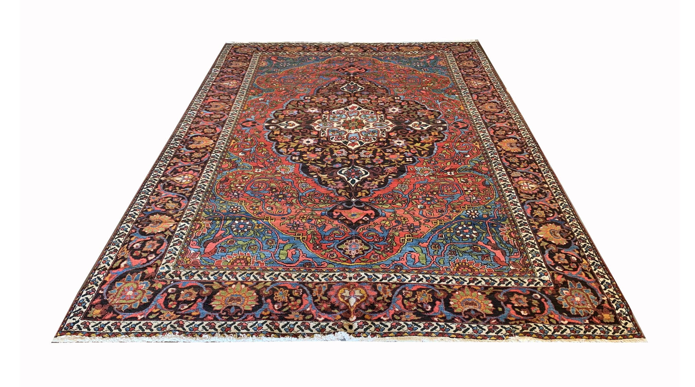This traditional antique medallion carpet is a handwoven masterpiece constructed in the 1900s. Displaying a Magnificent medallion and highly decorative surrounding composition. Symmetrically woven with flowing floral scrolls and a striking colour