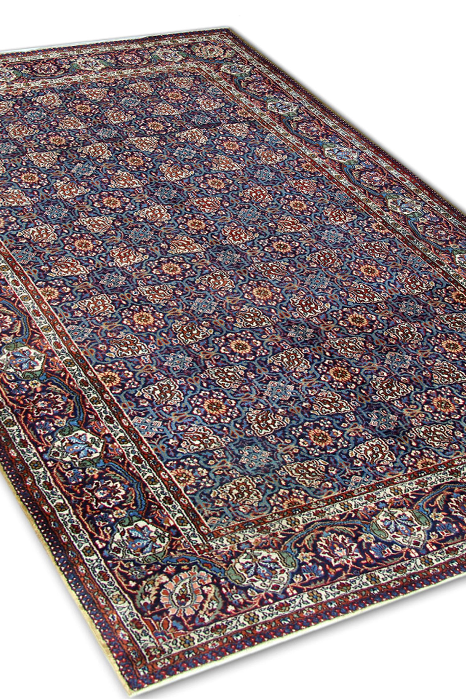 This antique Rug was hand-knotted circa 1900. They featured a navy blue field filled with a profusion of floral and geometrical elements intricately woven with a high level of detail. The repeat pattern central design is bordered by an equally