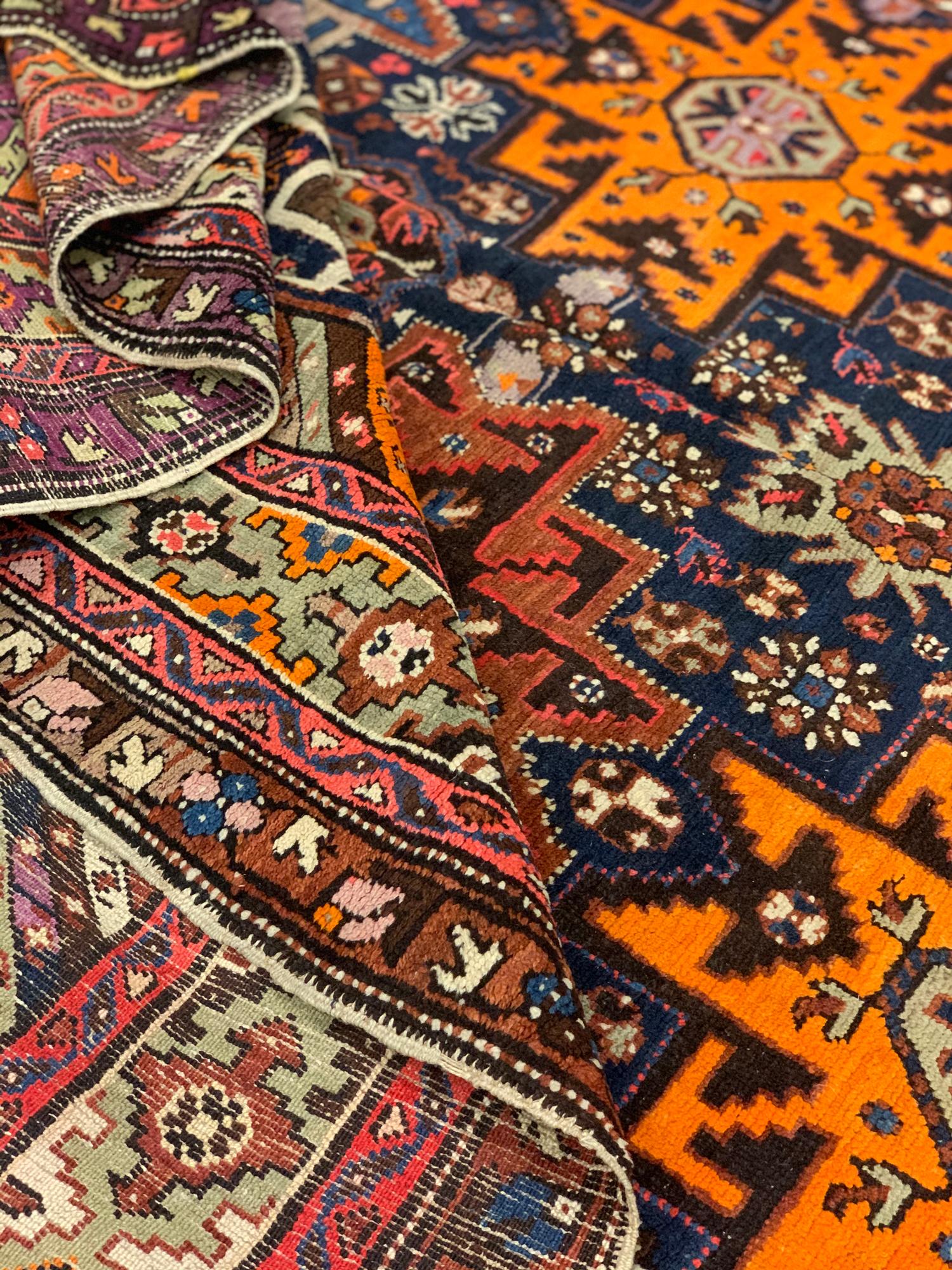 This fine Kazak wool area rug is a fantastic example of antique rugs woven in the early 21st century in the Kazak region of Caucasia. The design features a traditional geometric star pattern, traditionally seen in the Caucasian design. The bold