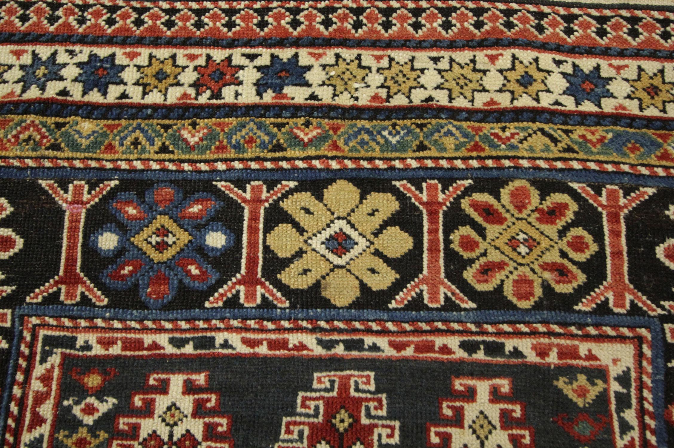 This handmade carpet is an exceptional example of Causation all-over patterned rugs. This geometric oriental rug is in an excellent condition, circa the 1870s. These small rugs are from Chichi, which is a part of the Caucasian area. This floral rug
