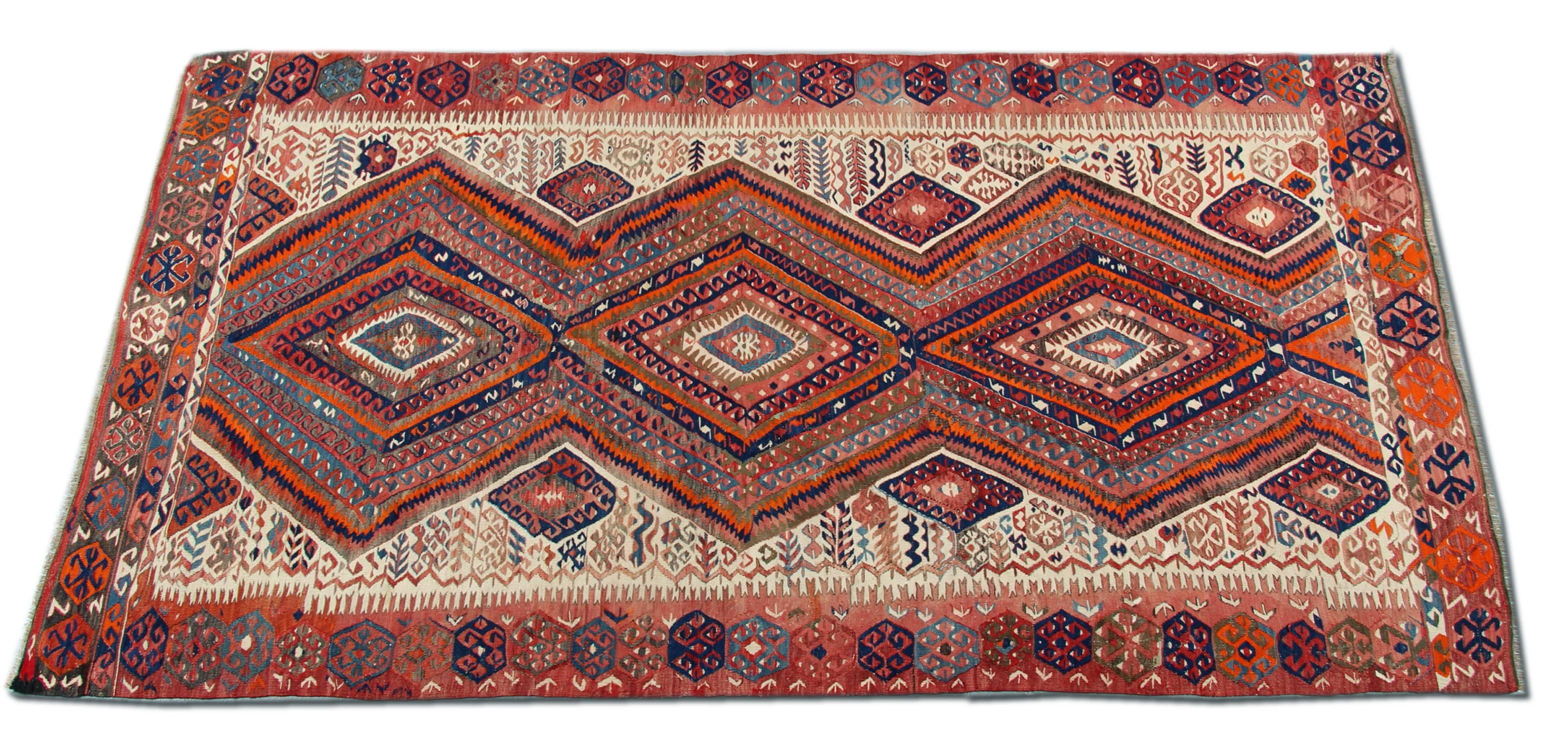 This antique Kilim Oriental rug is a Turkish handmade carpet rug has woven by very skilled weavers in Turkey, Anatolia, who used the highest quality wool and cotton. The flat-weave rug has light red, orange, grey-green, white, gold, yellow and dark