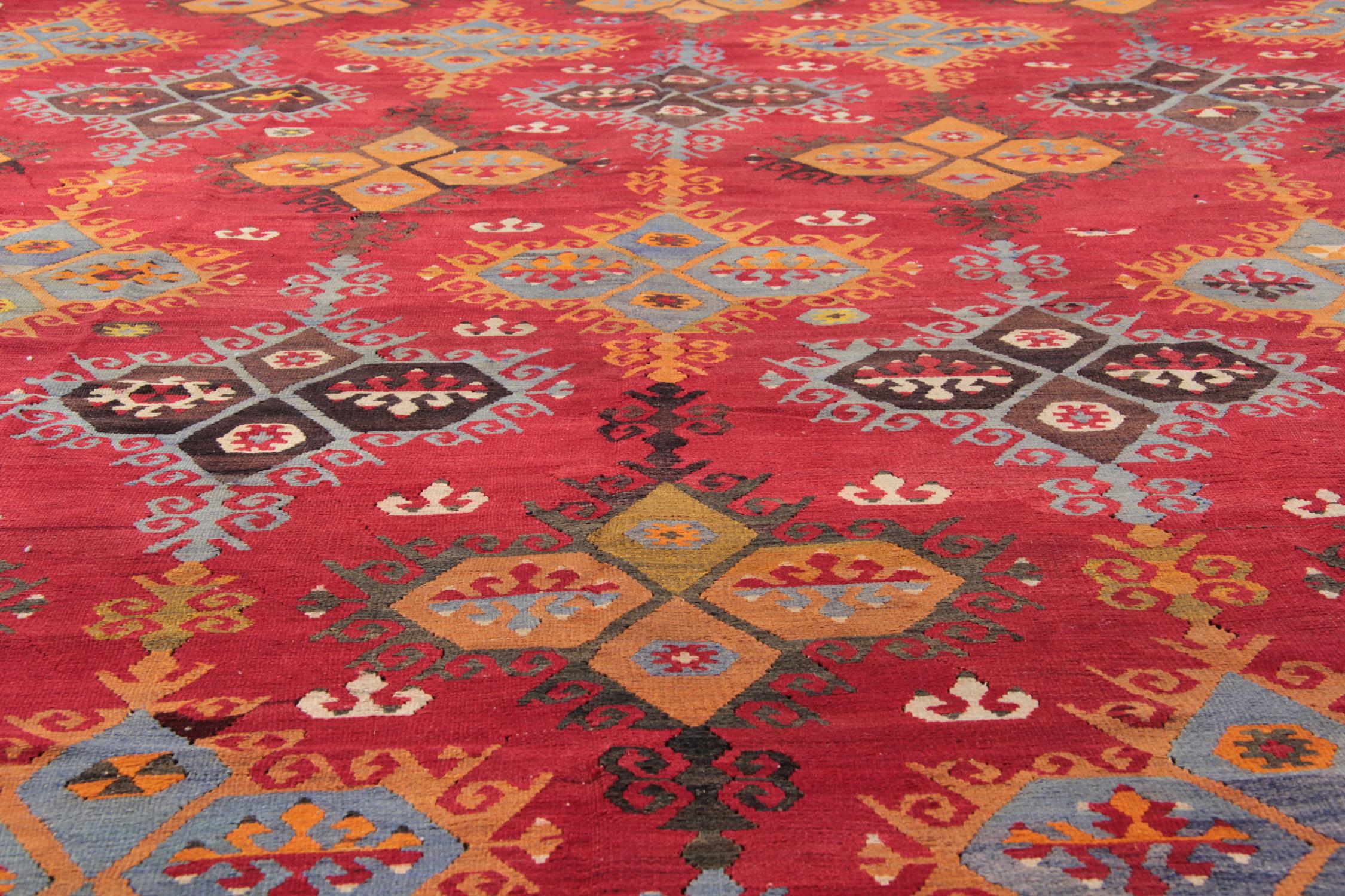 This Fantastic Red Turkish Kilim Rug has been beautifully Hand-made, Hand-Woven and dyed using traditional vegetable dyes to create one of the finest examples of antique kilim rugs. Featuring highly detailed symmetrical patterns across the rug and