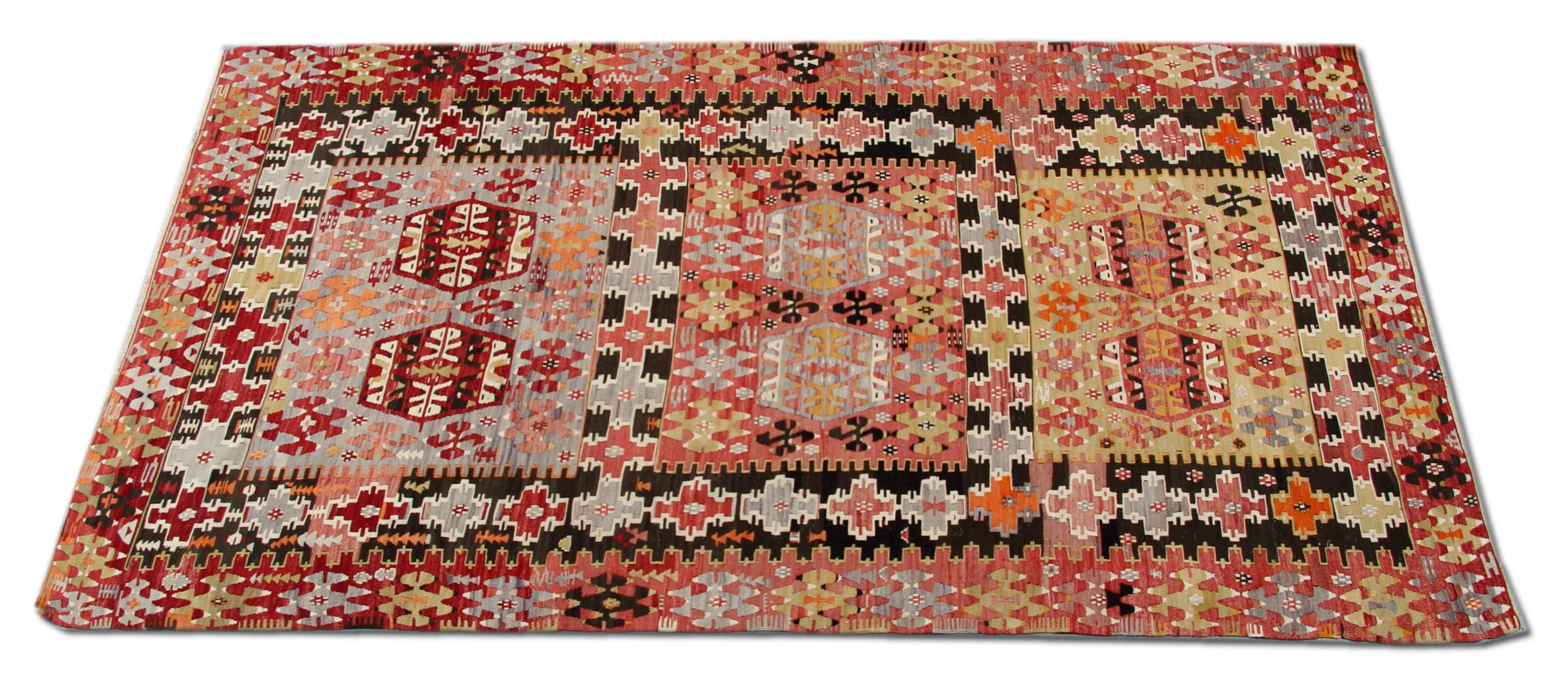 This handmade carpet floor rug is a Turkish carpet Oriental rug has woven by very skilled weavers in Turkey, who used the highest quality wool and cotton. The flat-weave rug has light red, orange, grey-green, white, gold, yellow and dark brown