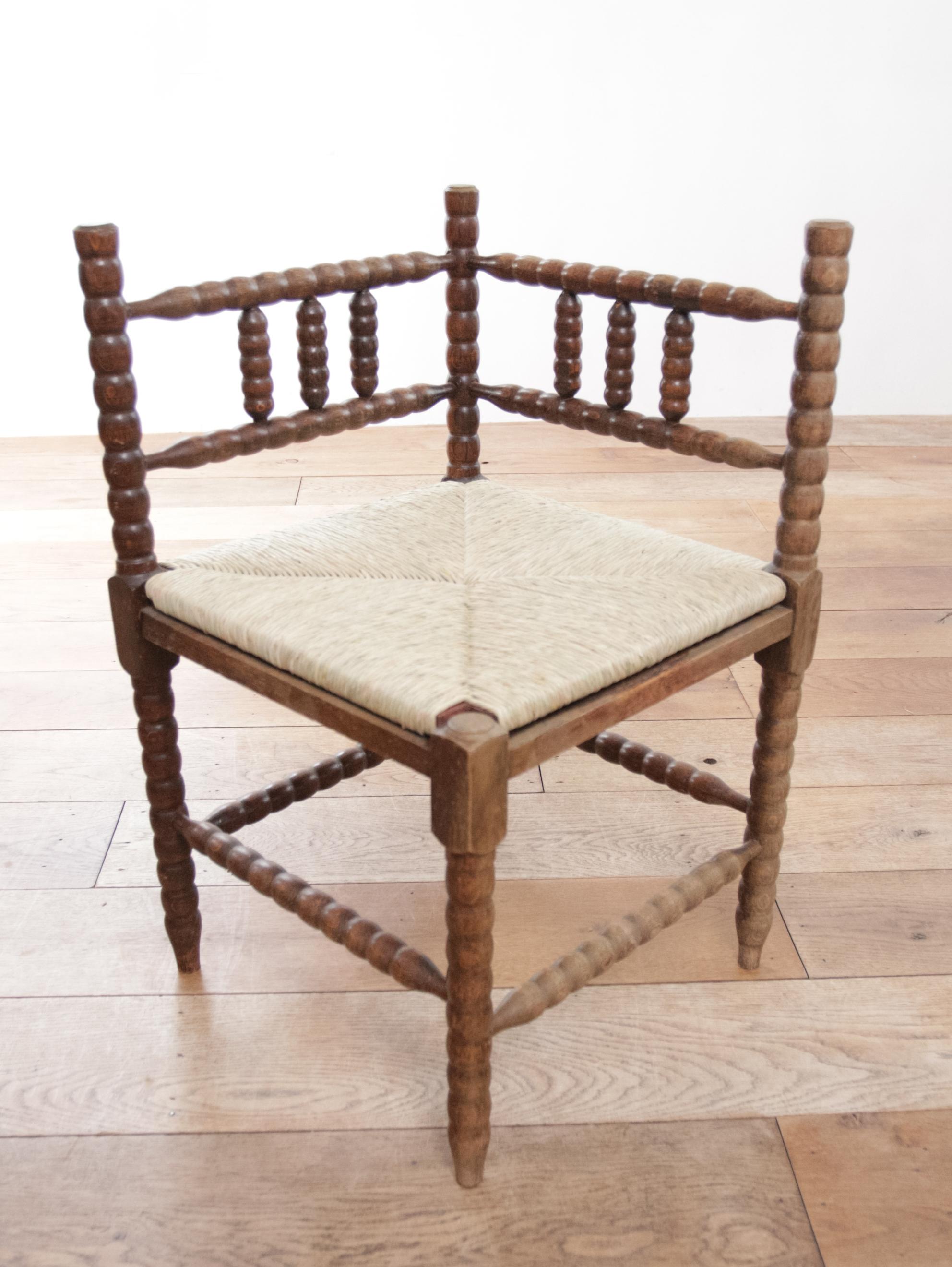 French Provincial Antique Rural Dutch Carved Corner Bobbin Chair with New Rush For Sale