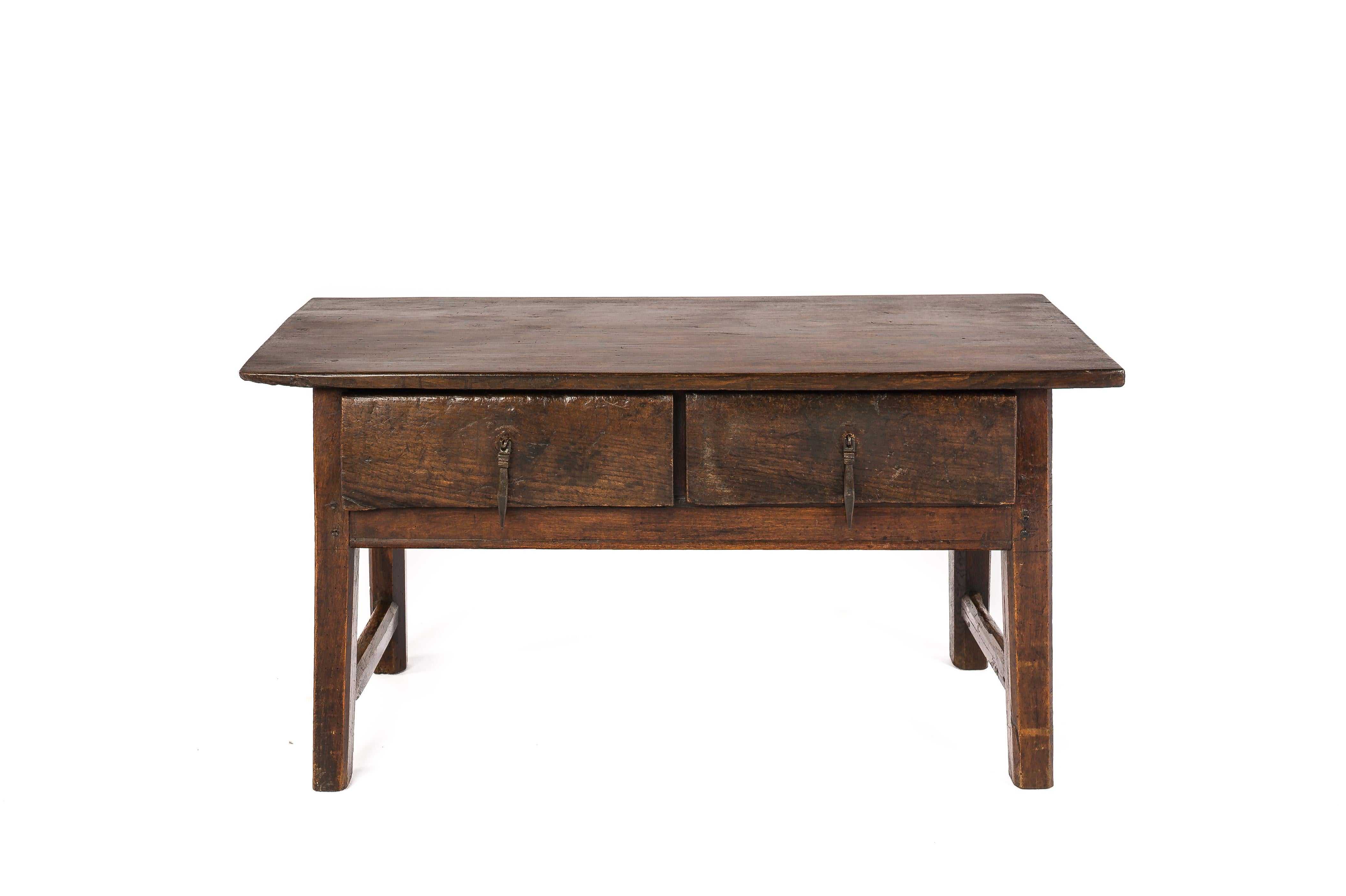 This beautiful table was made in rural Spain in the early 19th century. It was completely traditionally made in solid chestnut. The top was made from a single piece of wood and displays an intricate grain pattern typical for chestnut wood. The top