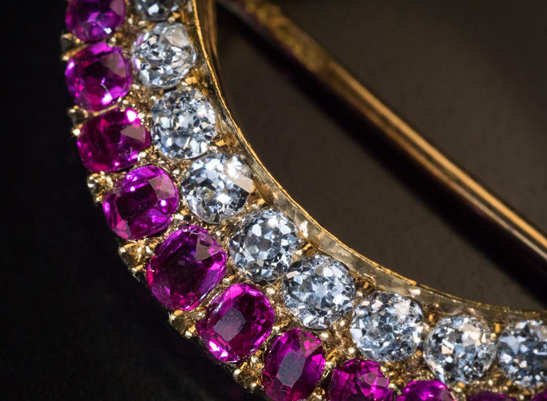 Made in St. Petersburg in the 1880s – 1890s.

This Victorian era crescent moon brooch is finely crafted in 14K gold. The crescent is set with a row of sparkling old mine cut diamonds and a row of well-matched natural rubies.

The brooch is marked on