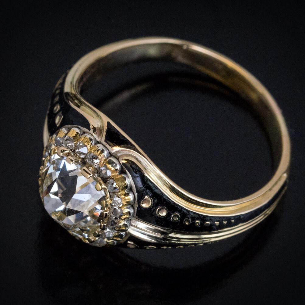 This very rare antique Russian ring was made in Moscow in the 1860s.

The ring is crafted in 14K yellow gold and embellished with glossy black enamel. It is centered with a chunky 2.24 ct old cushion cut diamond (K color, VS2 clarity). The diamond