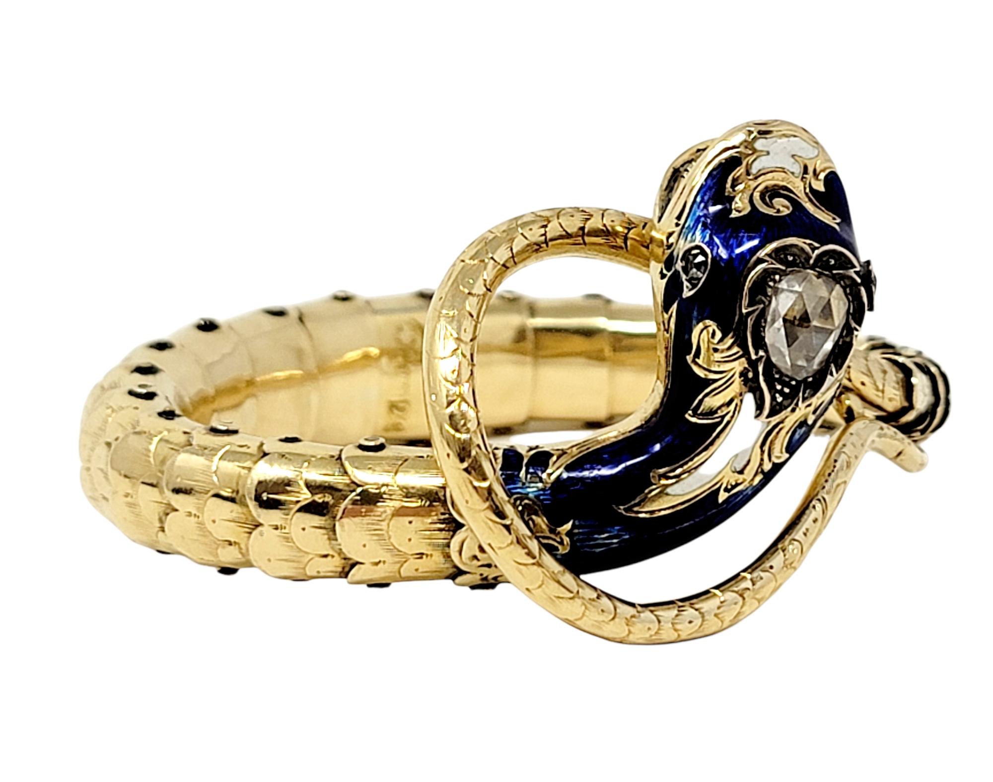 This incredible antique snake cuff bracelet is an absolute work of art! Featuring a flexible 14 karat yellow gold articulated body with scaled detailing, this snake slithers around your wrist for a perfect fit. The head of the serpent is highly