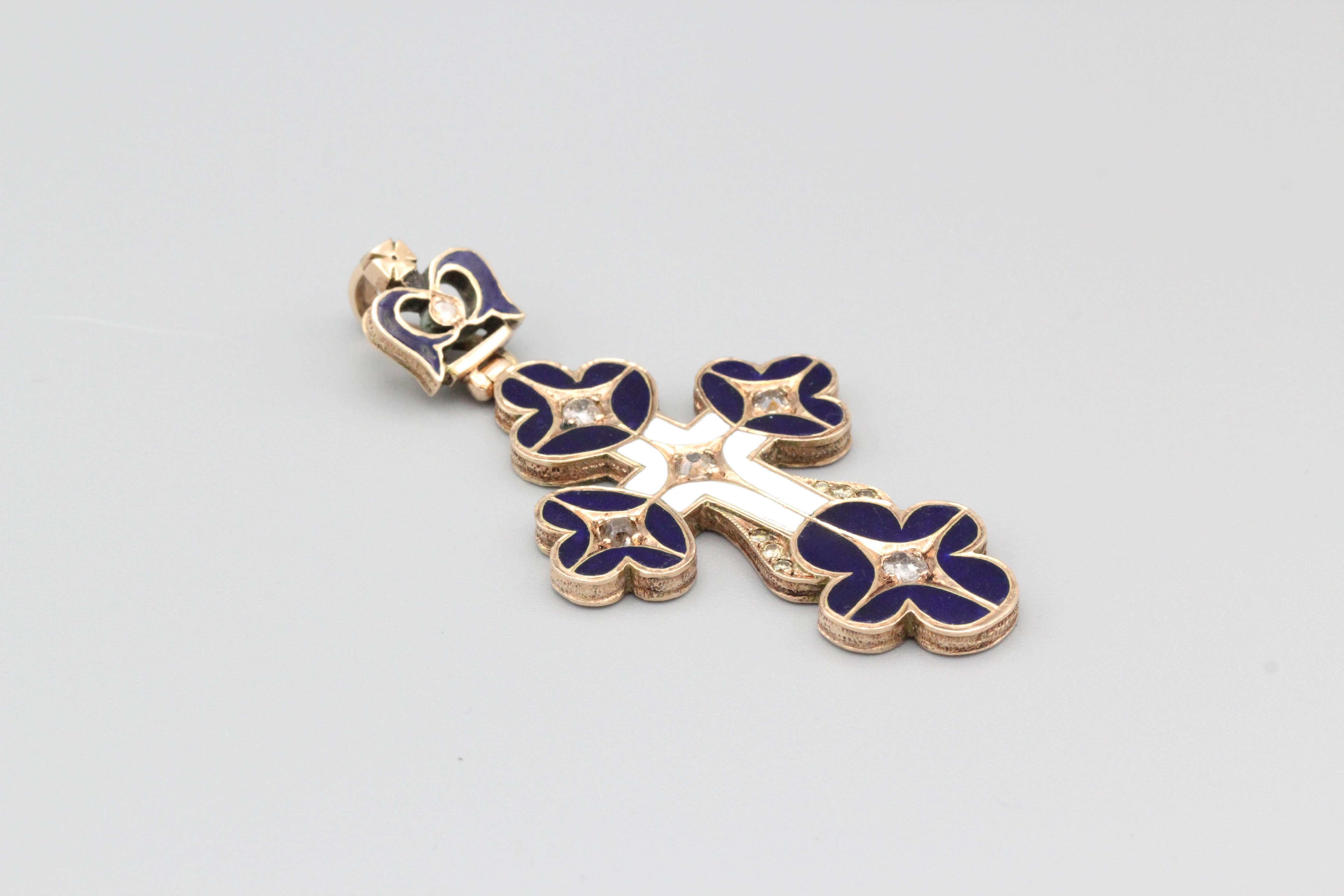 Fine diamond, enamel and 14K gold cross pendant of Russian origin, circa early 20th century. It features an ornate design with navy blue and white enamel. Diamonds are old cut.

Hallmarks: 56 (standard 14K gold mark), maker's mark.