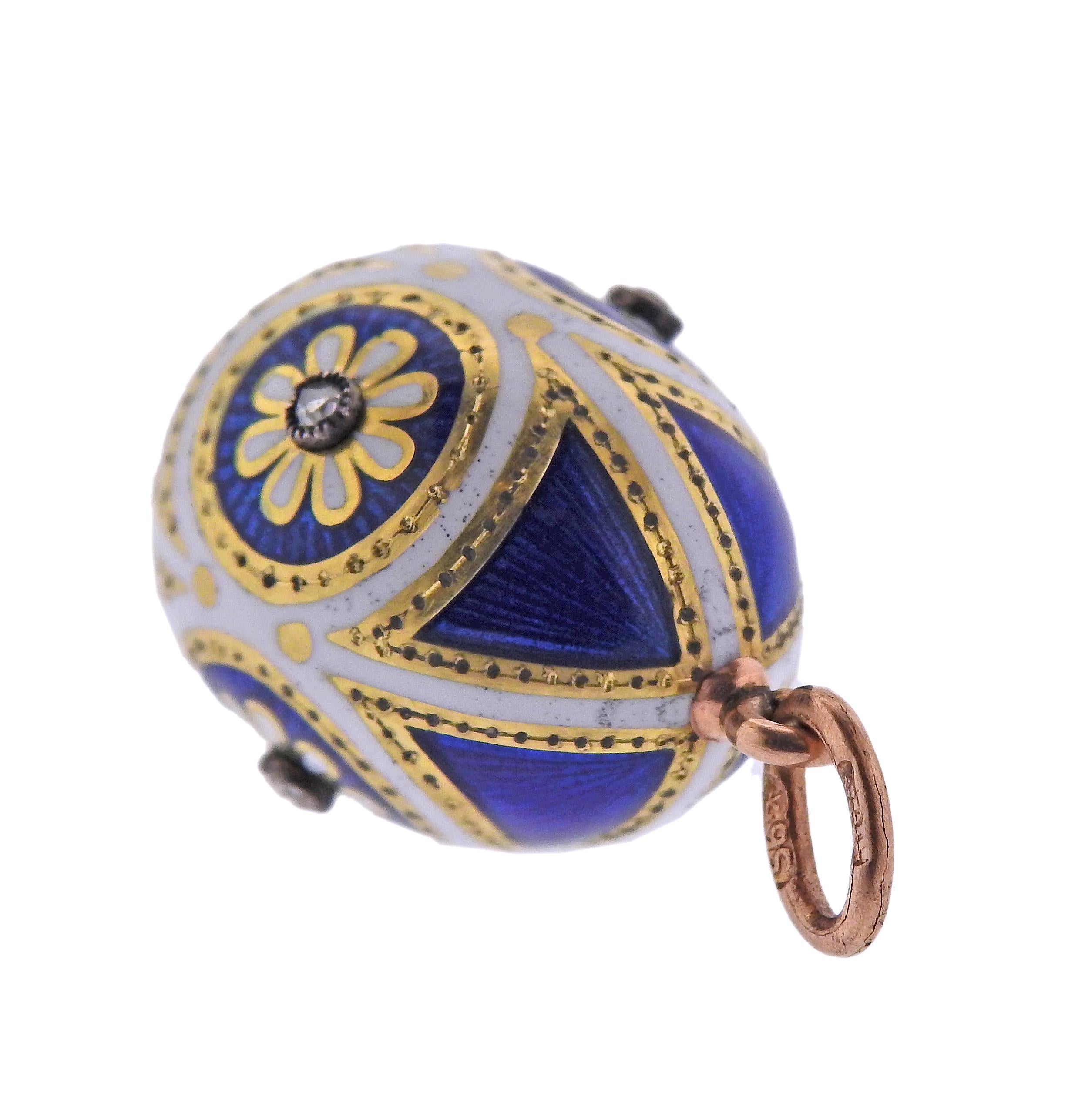 Antique Russian 18k gold and silver egg pendant, with blue and white enamel ornament and rose cut diamonds. Pendant measures 26mm long with bale x 14.5mm in diameter of the center/widest point. Marked with Russian hallmarks on the bale. Weight -