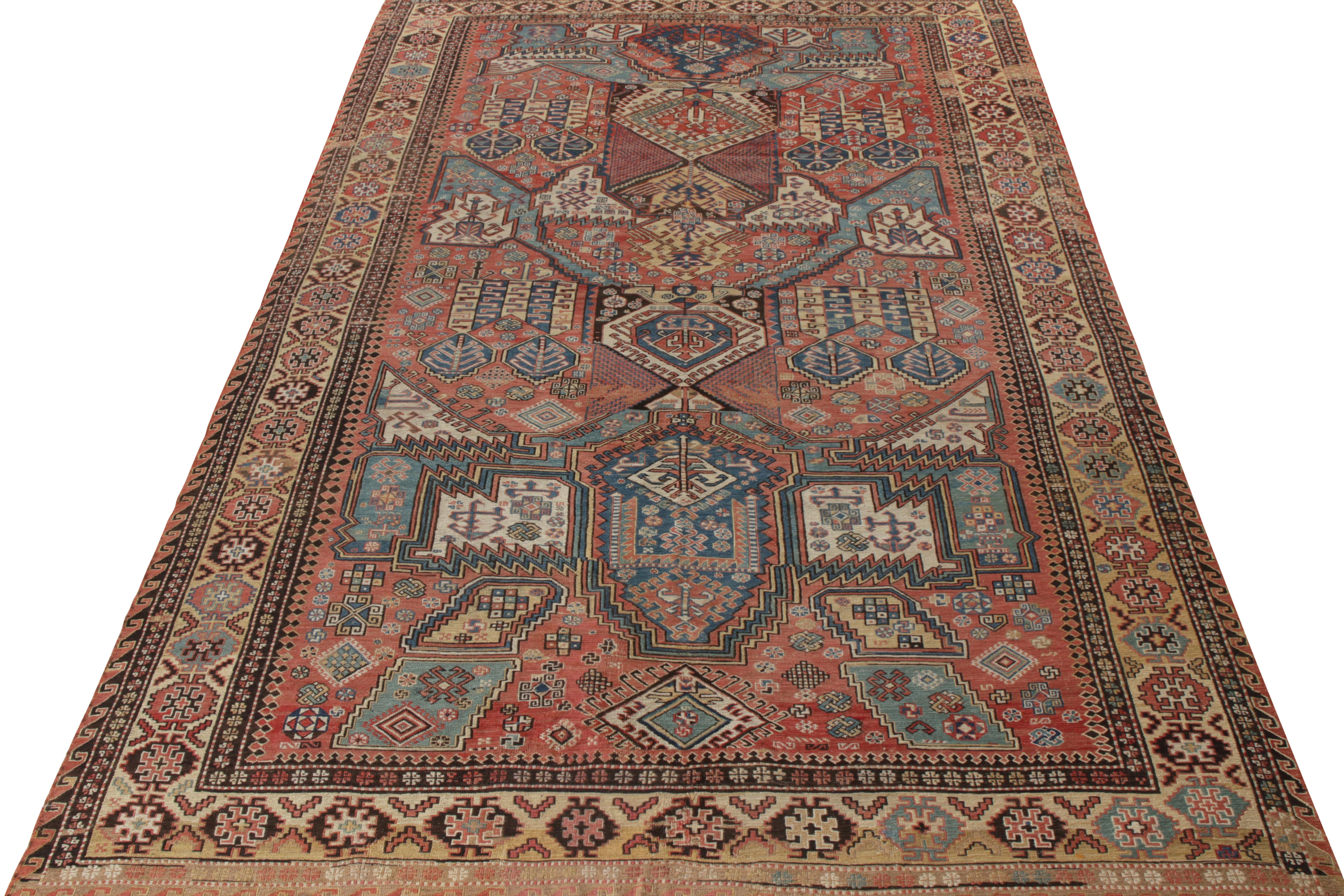 Hand knotted in wool, a rare antique dragon Soumak rug originating from Russia circa 1920-1930, relishing a union of a sought-after blue, beige-brown, and red colorway with a well defined geometric pattern filling the scale with a traditional
