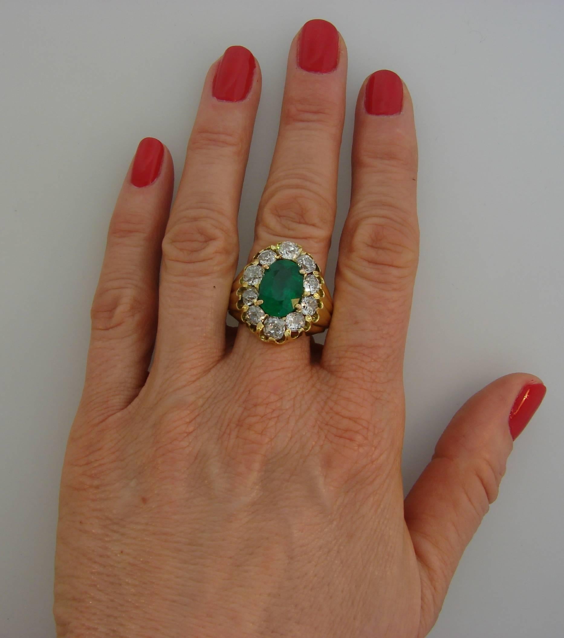 A beautiful ring created in Russian Empire in 1850 (the year of manufacture is stamped on the shank). It is made of yellow gold, and features a 4.65-carat oval faceted emerald framed with ten cushion cut diamonds (H-I color, VS2-SI1 clarity, total