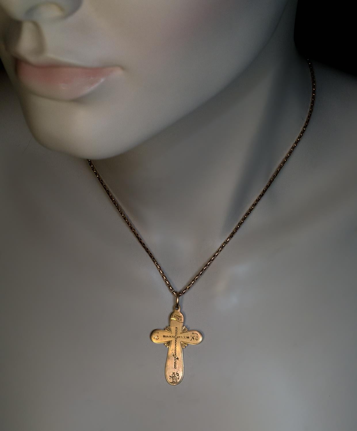 This antique Russian 14K yellow gold cross pendant with hand-engraved decorations was made in St. Petersburg in the 1880s – 1890s.
The abbreviation ‘IC’ – ‘XC’ on the horizontal arms of the cross stands for Jesus Christ.
The cross is marked on back