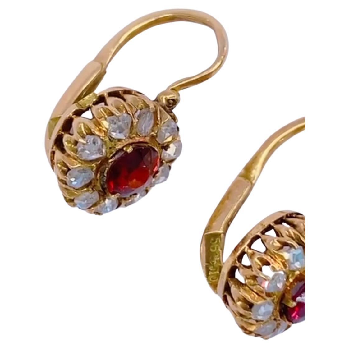 Antique imperial Russian era 1880s Garnet 14k gold earring centered with 2 round cut Garnet flanked with rose cut diamonds with an earrings head diameter 5.25mm made in Moscow 1880/1890.c hall marked with Moscow assay mark st George slaying the