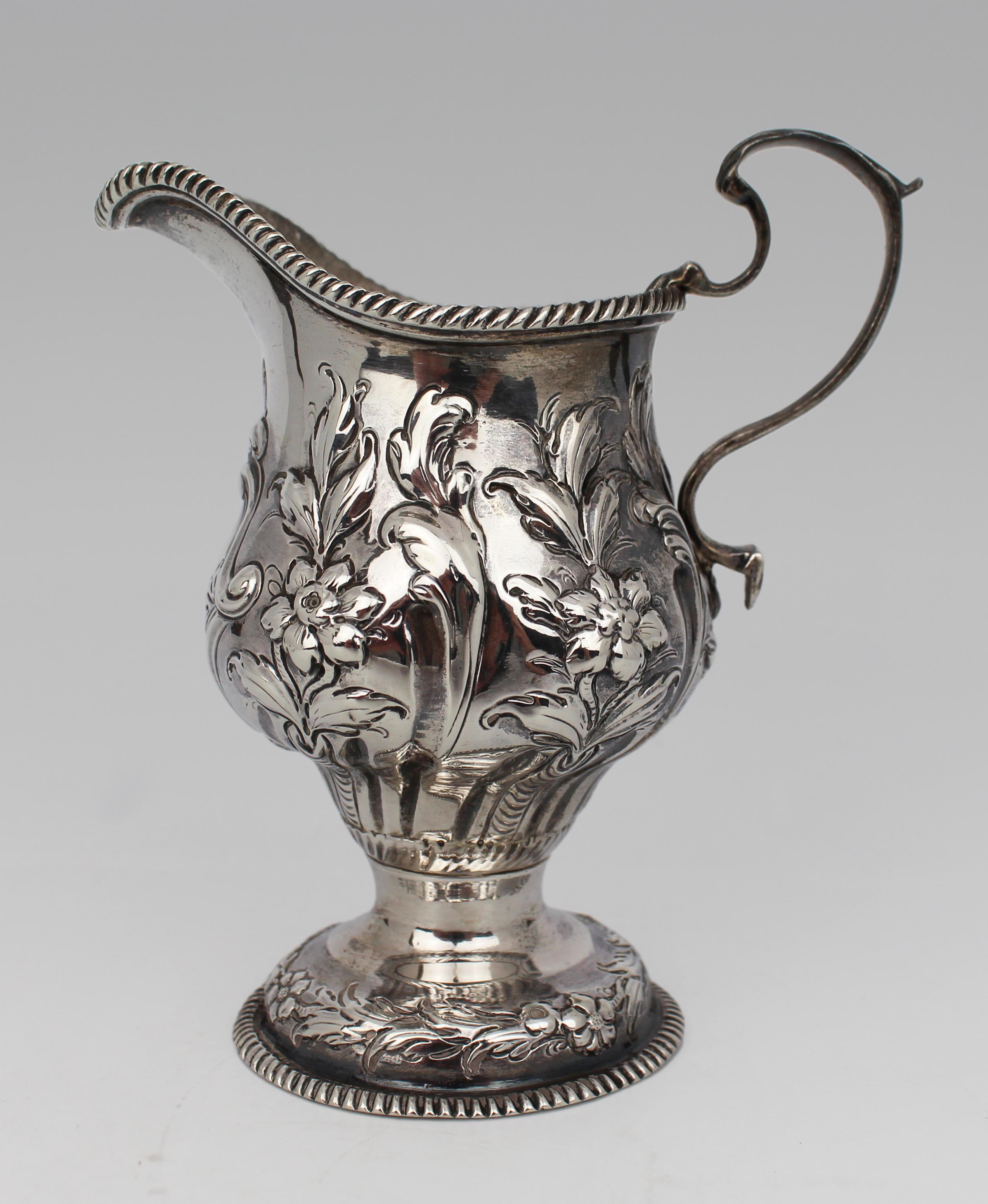 18th Century English Georgian Solid Silver Cream Ewer – London, 1759
A finely executed Georgian silver cream ewer, hallmarked for London, 1759. This elegant piece is crafted in sterling silver and displays richly detailed repoussé floral decoration