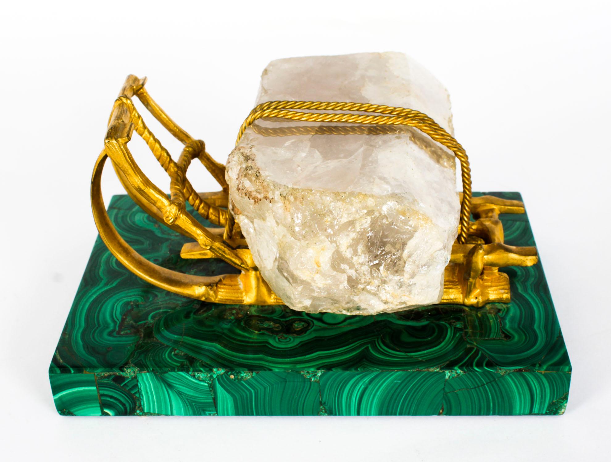 This is a truly magnificent and rare antique Russian gilt bronze, malachite and rock crystal desk stand sculpture, circa 1870 in date.

This exceptionally executed sculpture is in the novelty form of a gilt bronze winter sleigh carrying a