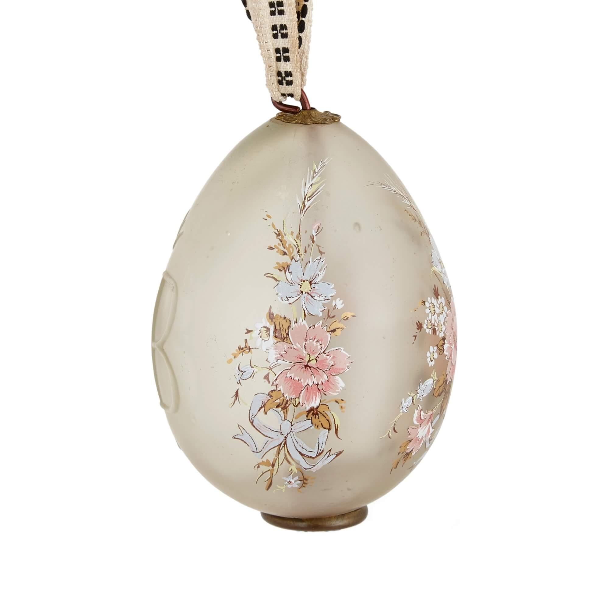 Antique Russian glass egg with enamel decoration
Russian, early 20th Century
Height 10cm, diameter 7cm

This fine glass egg is delicately formed, with the front and sides featuring floral bouquets in pastel shades executed in enamel, and the reverse