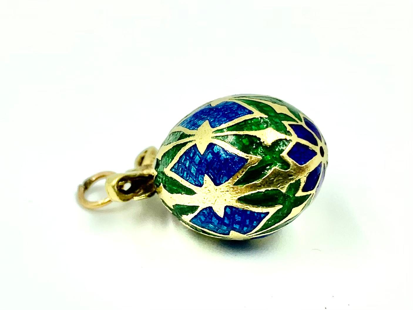 Antique Russian Gold and three color guilloche enamel Easter egg pendant. The geometric design of this beautiful pendant focuses on the number 8, a number associated with infinity, spiritual balance and a symbol of new beginnings. At the top and