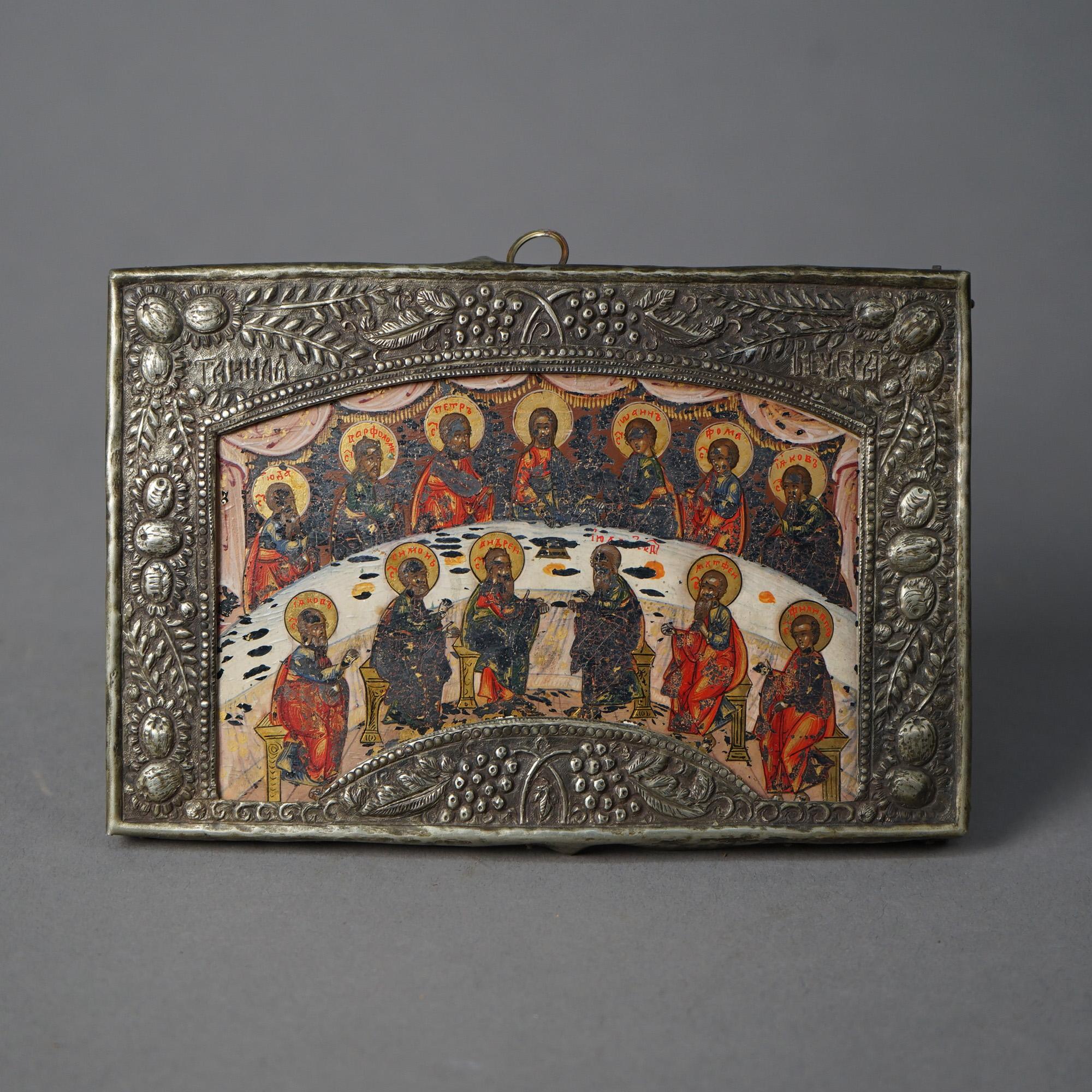 An antique Russian Icon depicting Jesus Christ and His Disciples at the Last Supper, rizza embossed with grape, olive and leaf; signed in upper corners on rizza; 19th C

Measures - 5.5