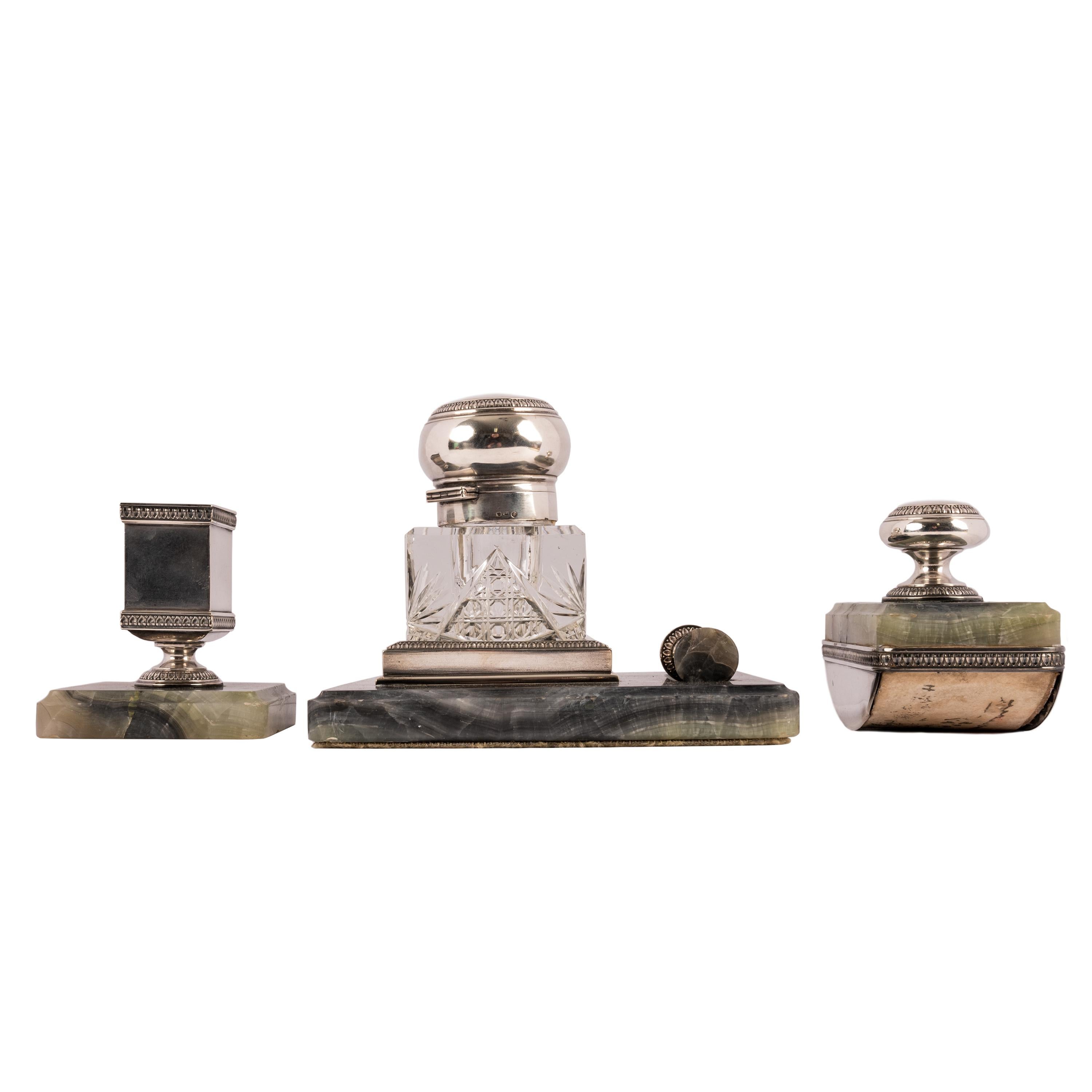 A good antique Russian Imperial silver and onyx four piece desk set, circa 1896.
The set having variegated onyx bases and silver mounts,  comprising a cut glass inkwell (which is removeable from the silver and onyx base), plus a seal to close