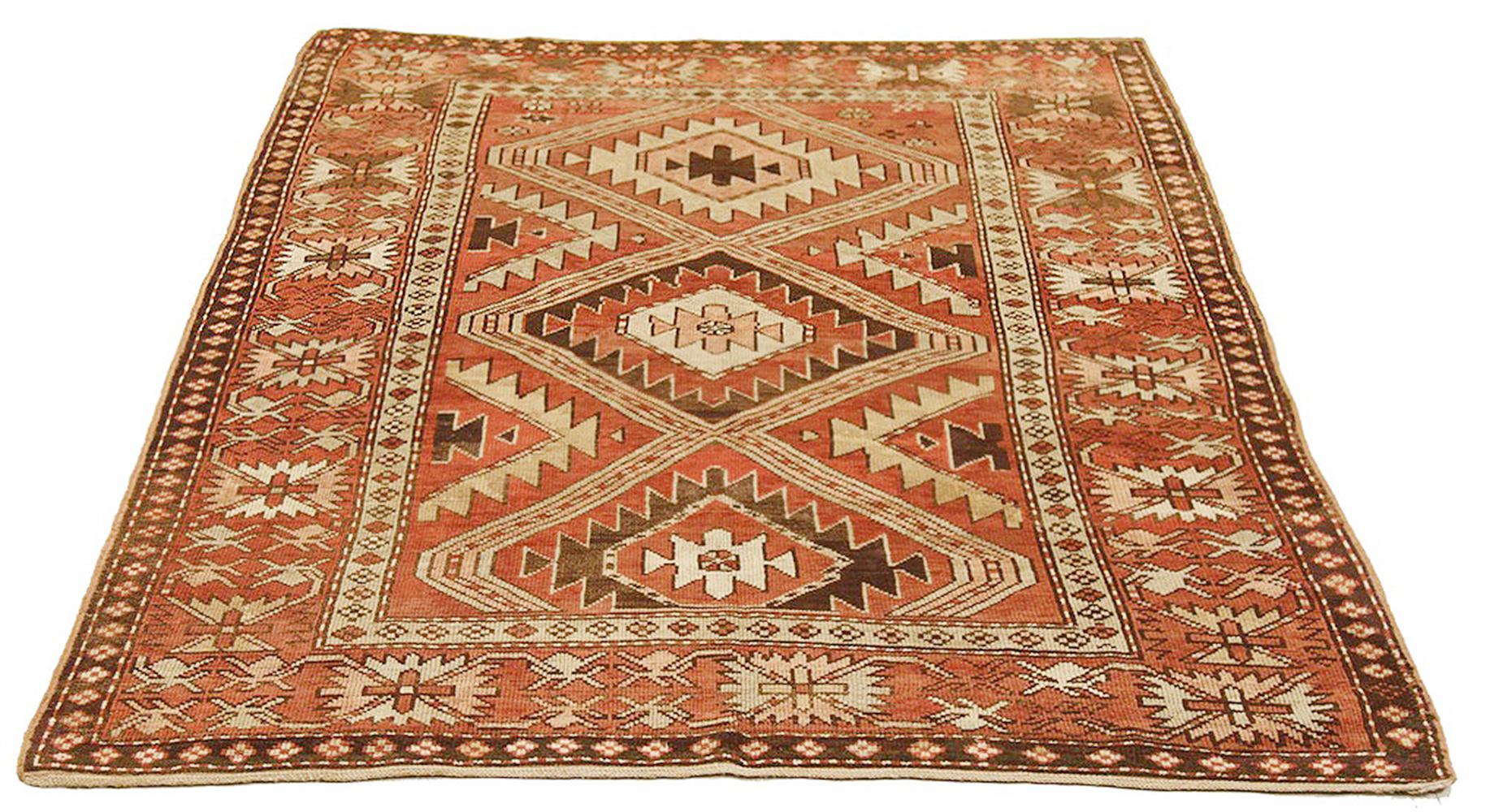 Antique Russian rug handwoven from the finest sheep’s wool and colored with all-natural vegetable dyes that are safe for humans and pets. It’s a traditional Kazak design featuring geometric medallion details in beige and brown over a beige field.