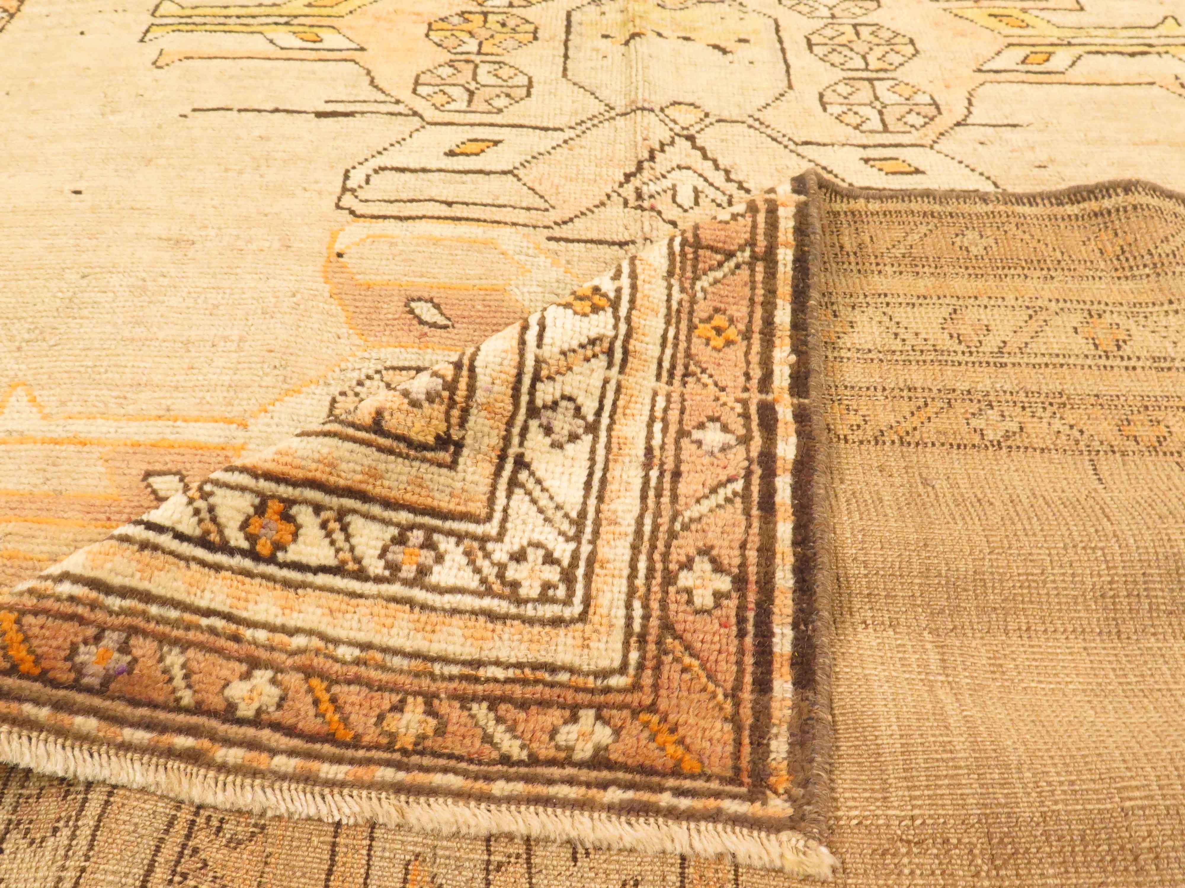 Antique Russian rug handwoven from the finest sheep’s wool and colored with all-natural vegetable dyes that are safe for humans and pets. It’s a traditional Kazak design featuring Scarab medallion details in beige and black over an ivory field. It’s