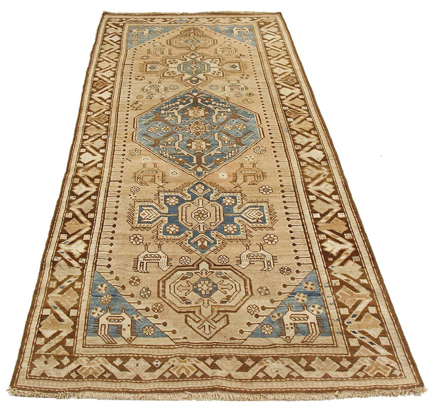Antique Russian rug handwoven from the finest sheep’s wool and colored with all-natural vegetable dyes that are safe for humans and pets. It’s a traditional Kazak design featuring floral medallion details in brown and blue over a beige field. It’s a