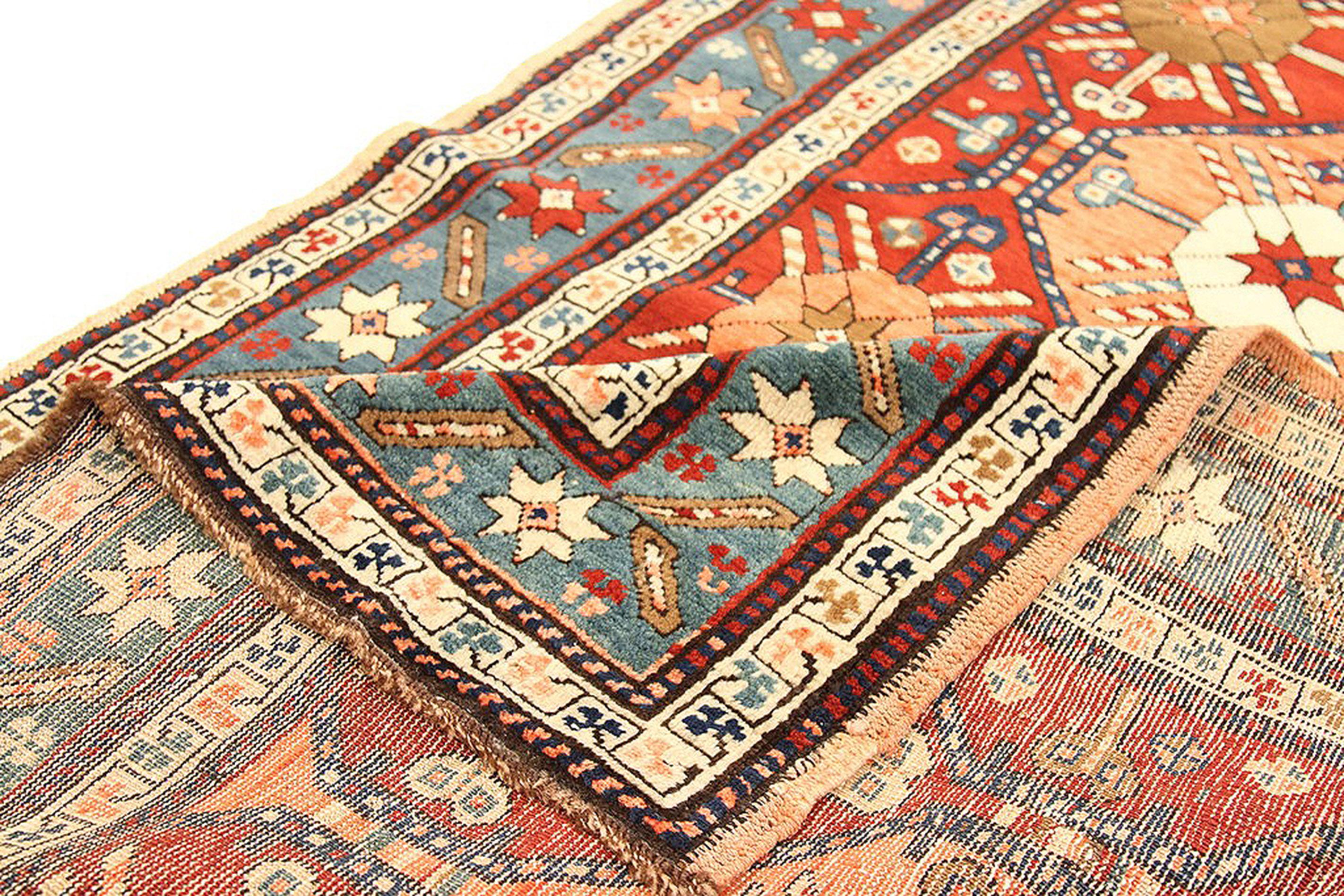 Antique Russian runner rug handwoven from the finest sheep’s wool and colored with all-natural vegetable dyes that are safe for humans and pets. It’s a traditional Kazak design featuring star and geometric medallion details in various colors over an
