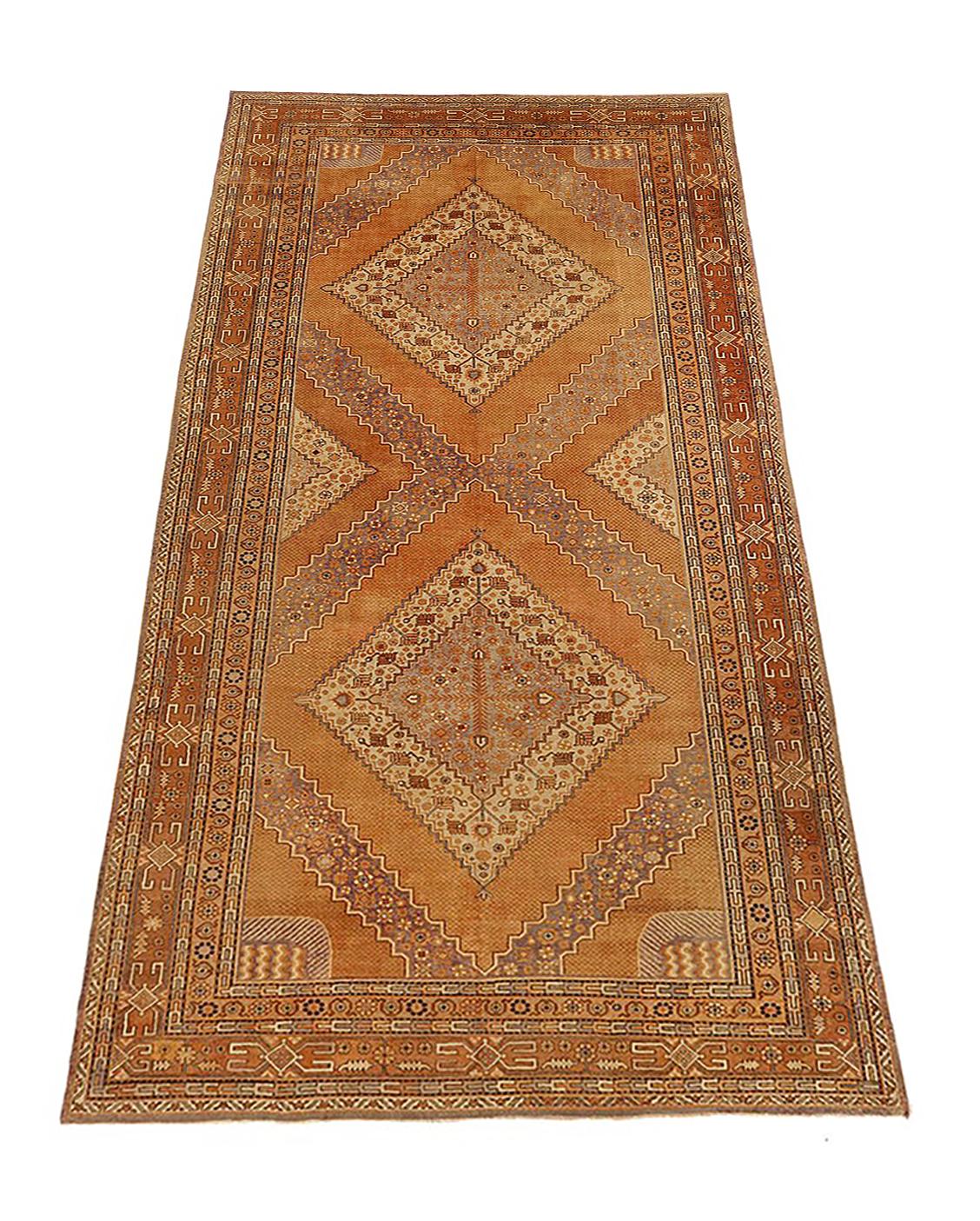 Antique Russian rug handwoven from the finest sheep’s wool and colored with all-natural vegetable dyes that are safe for humans and pets. It’s woven using Khotan design featuring a mix of large diamond medallion patterns in beige and brown. It’s a