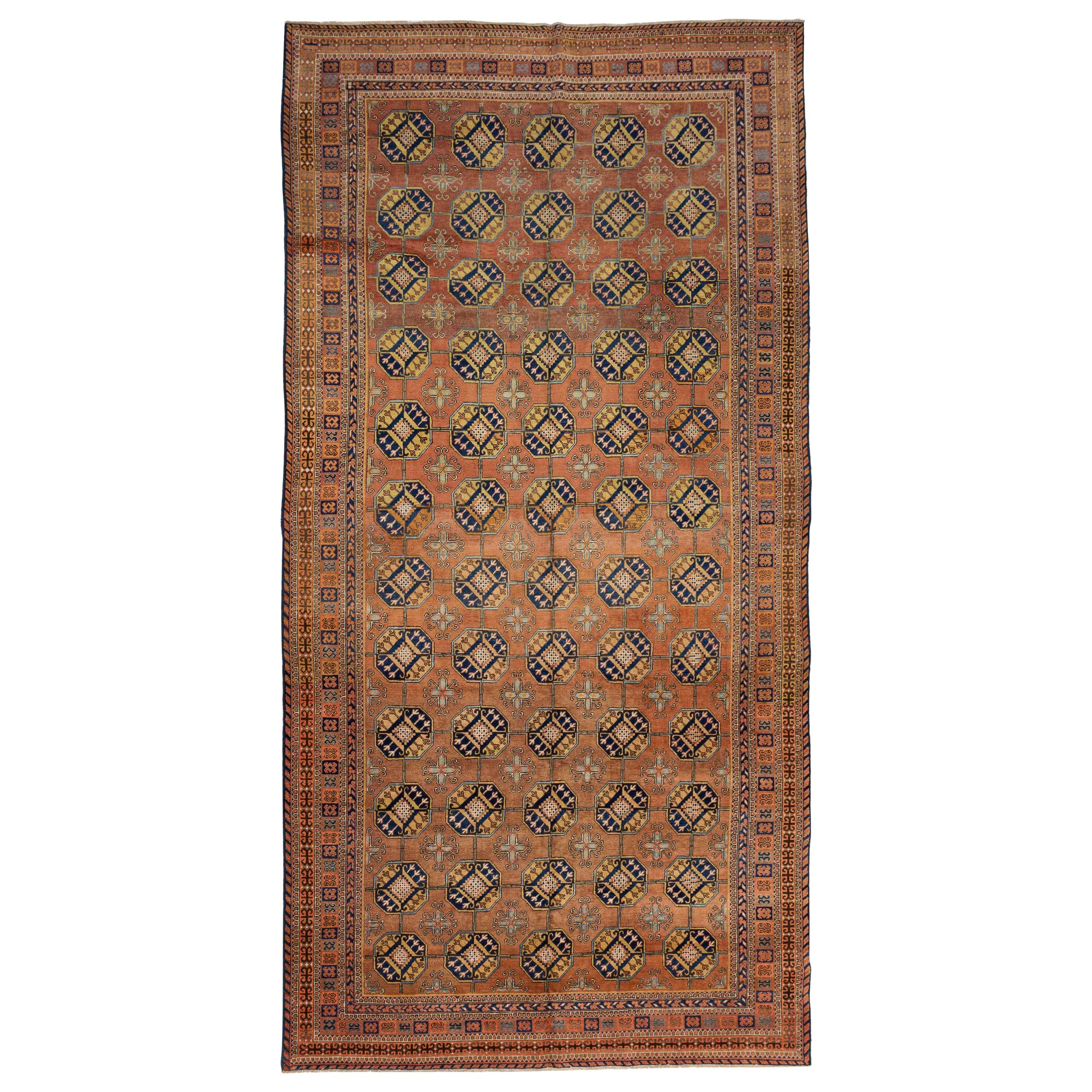 Antique Russian Khotan Rug with Beige & Navy Octagon Medallions on Orange Field For Sale