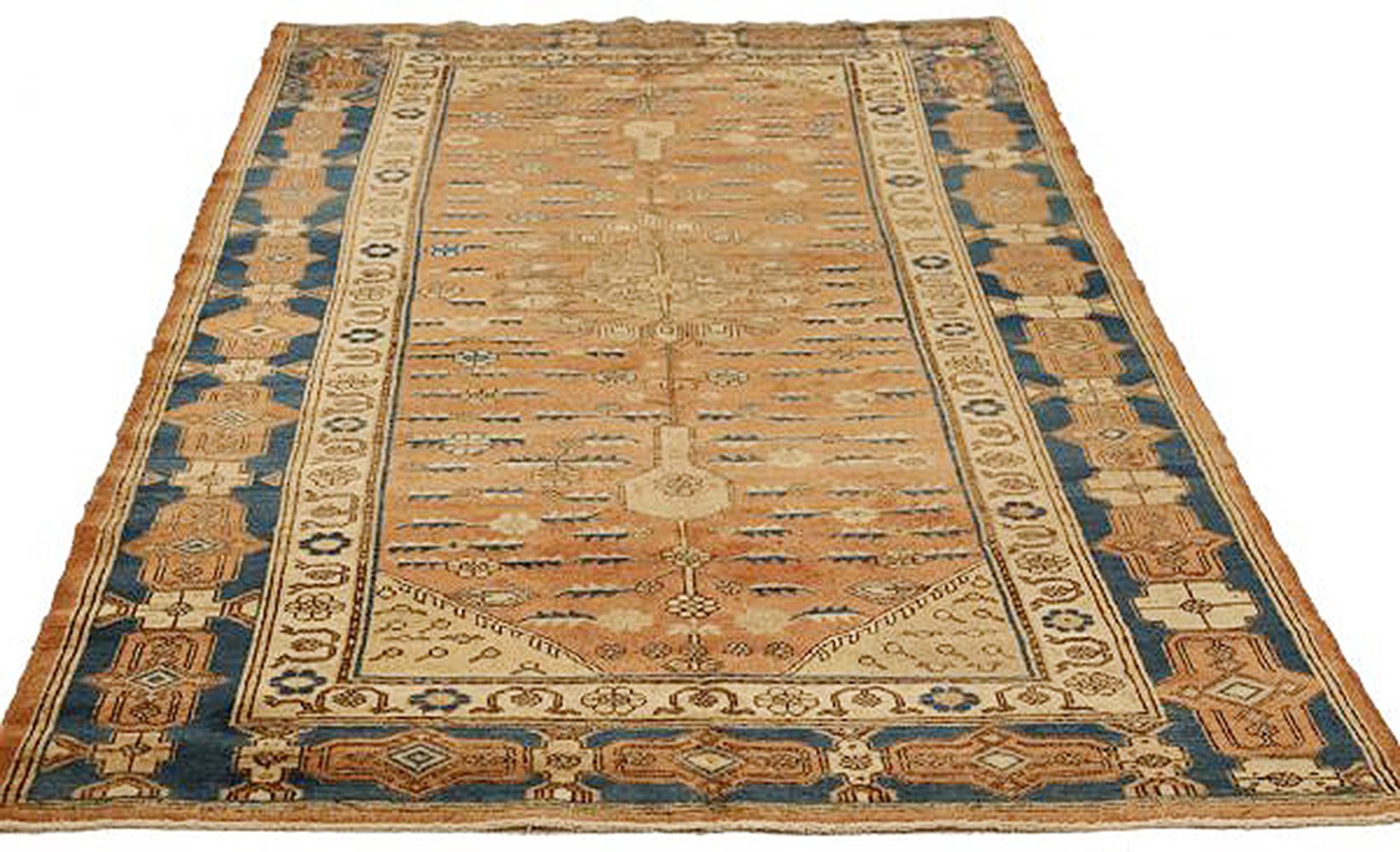 Antique Russian rug handwoven from the finest sheep’s wool and colored with all-natural vegetable dyes that are safe for humans and pets. It’s woven using a Khotan design featuring a mix of floral patterns in blue and beige. It’s a beautiful piece
