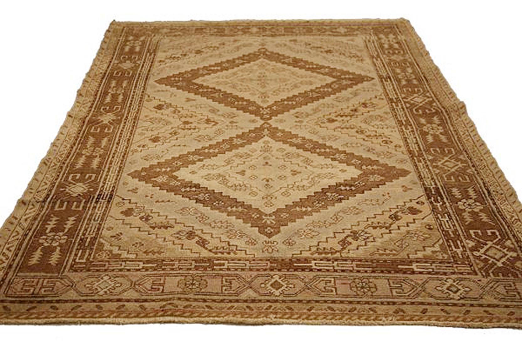 Antique Russian rug handwoven from the finest sheep’s wool and colored with all-natural vegetable dyes that are safe for humans and pets. Its woven using Khotan design featuring large diamond shaped central medallions over a beige field. It’s a