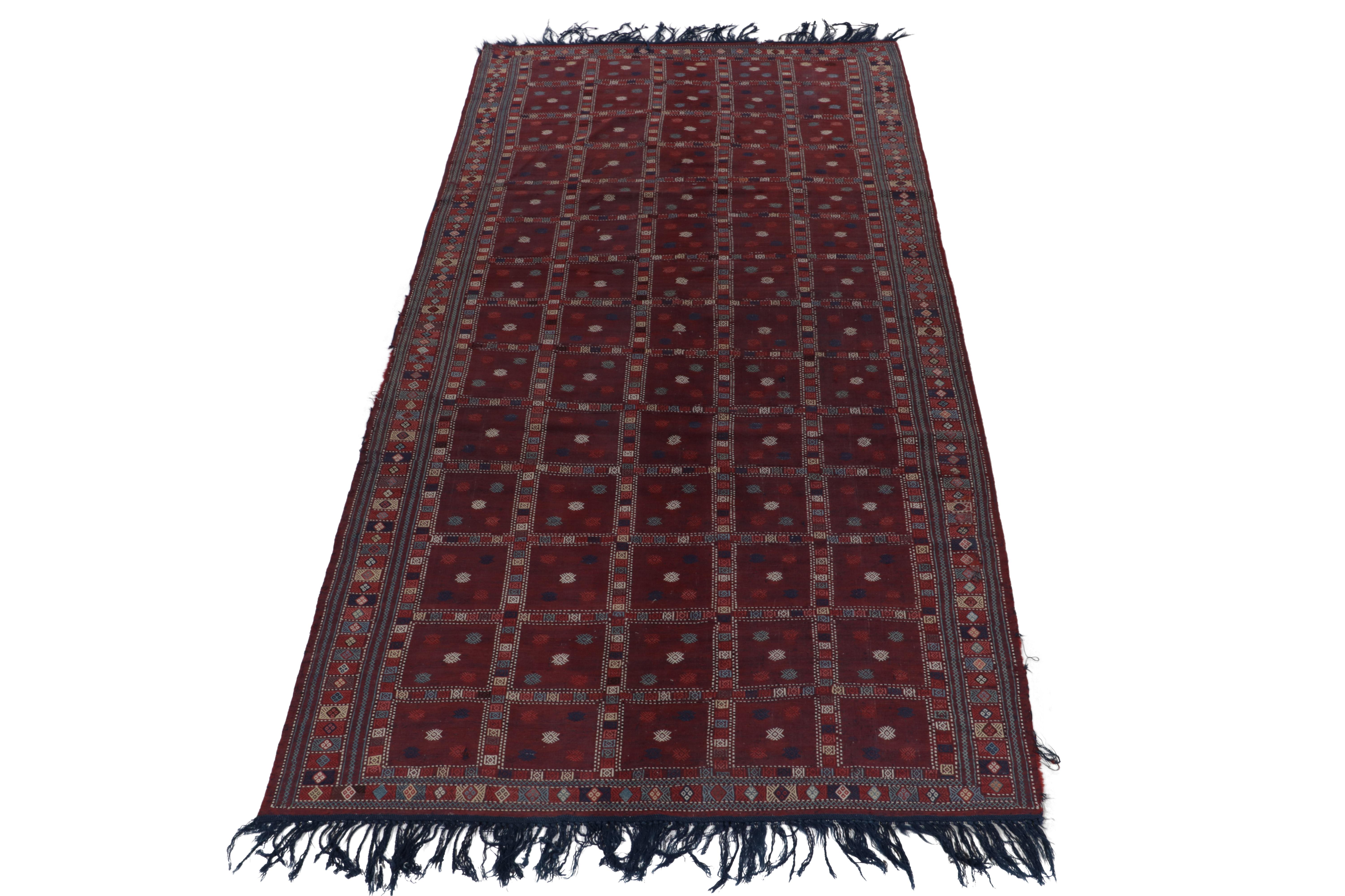 Handwoven in wool, a 6 x 12 antique Russian kilim exemplifying tribal Caucasian aesthetics—now entering Rug & Kilim’s flatweave selections. The deep wine and bordeaux red tones complement the simple geometry with light intricacies in aegean blue,