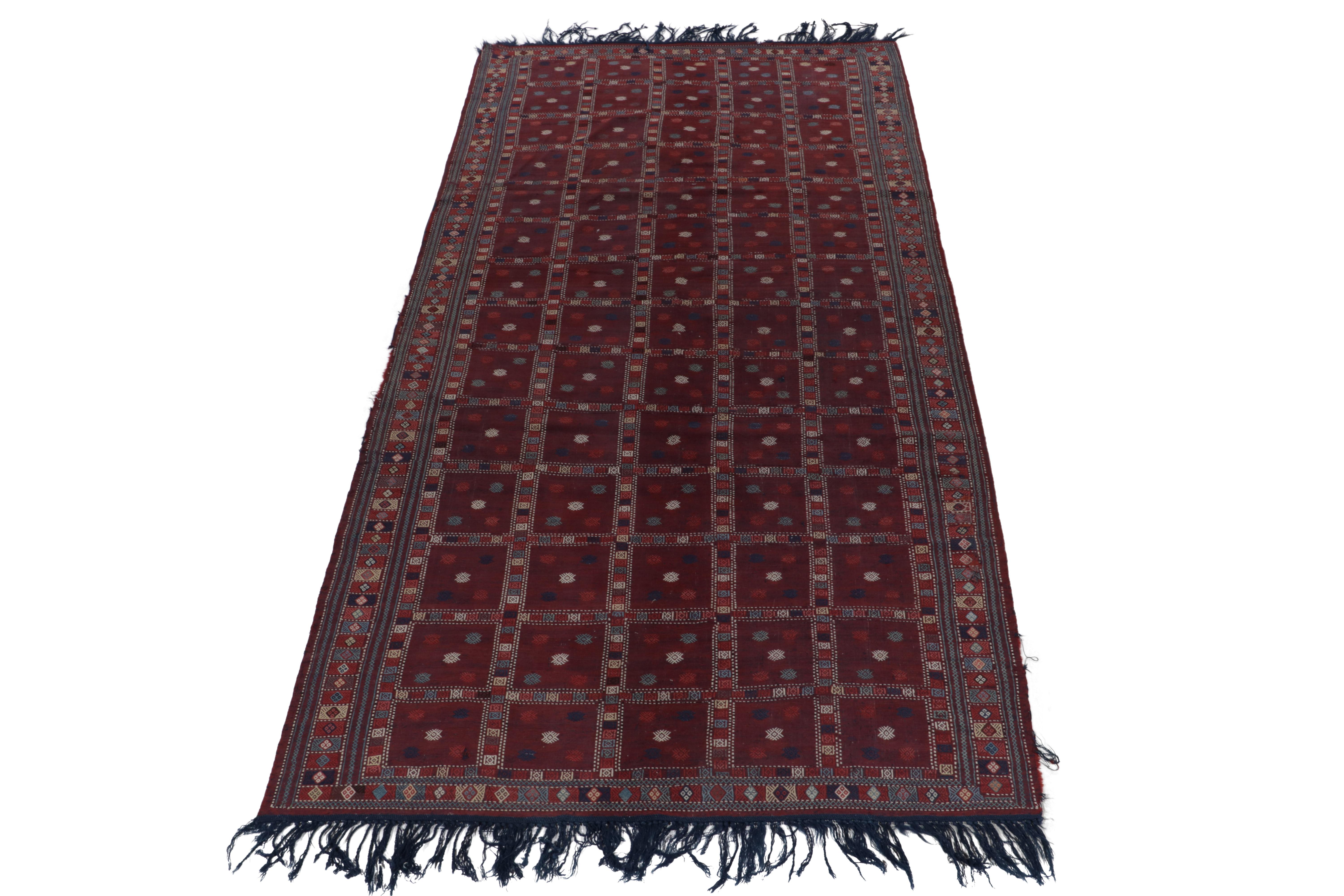 Tissé à la main en laine, un kilim russe ancien de 6 x 12 illustrant l'esthétique tribale caucasienne, qui fait maintenant partie des sélections de tissage plat de Rug & Kilim. Les tons profonds de vin et de rouge bordeaux complètent la géométrie