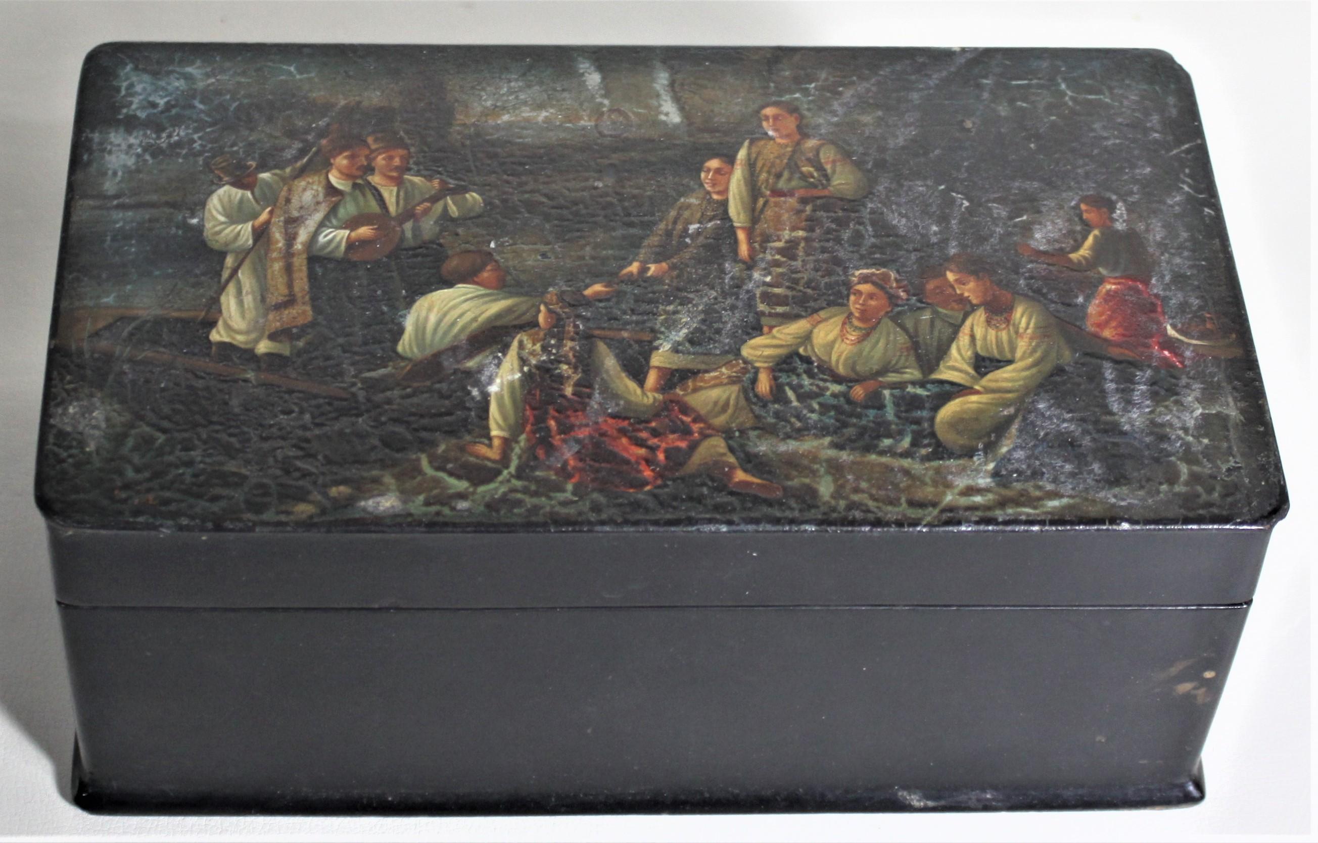 This antique wooden box is unmarked and unsigned, but believed to have been made in Russia in circa 1890. The top of the box portrays a vignette of a shore scene where several men in a small boat pay a visit to several women on the shore. The entire