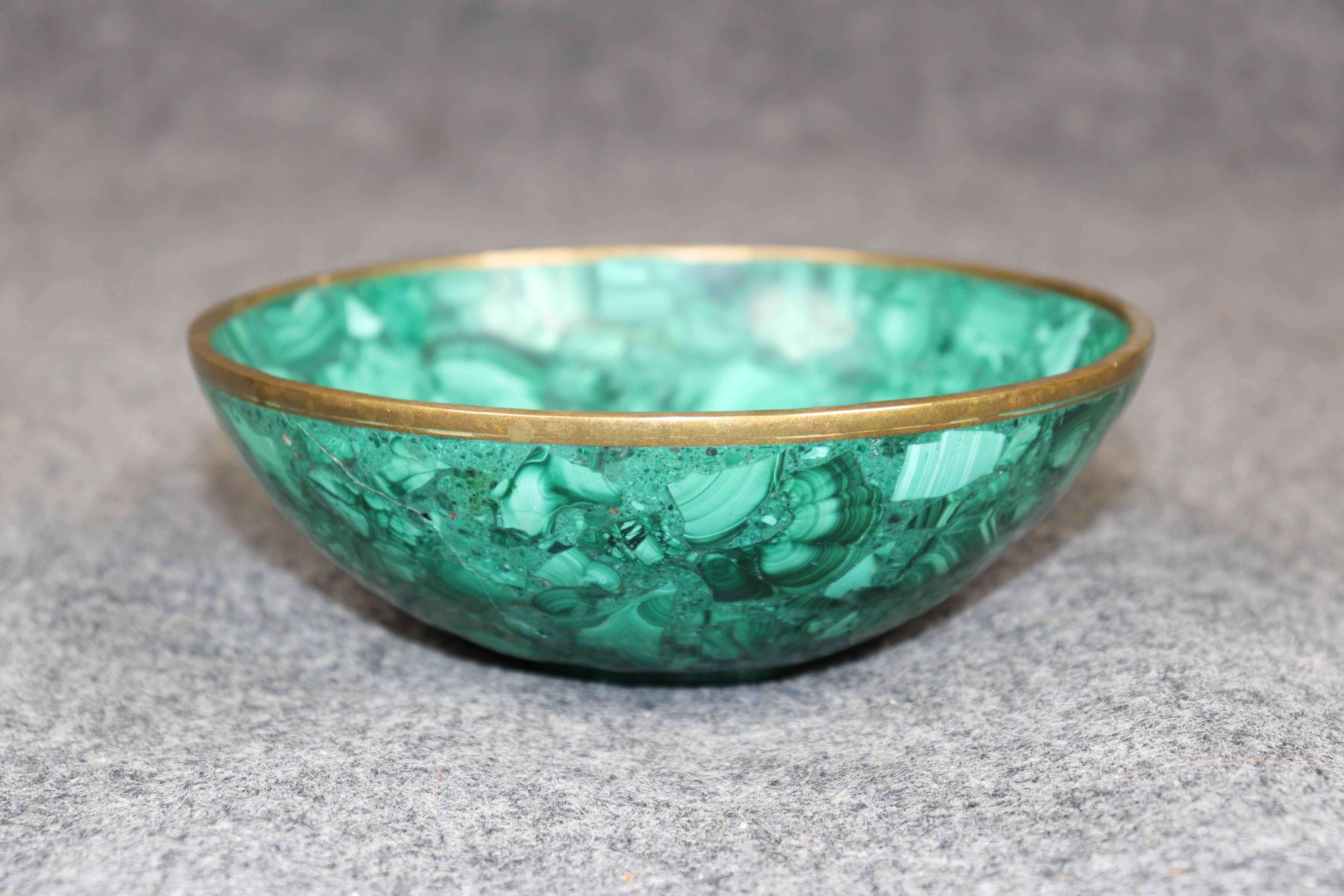 Dimensions - H: 2 1/4 in W: 6 1/2 in D: 6 1/2 in 

This exquisite early 20th century Russian malachite bowl is a stunning example of fine craftsmanship and classical design. Beautifully carved from richly veined genuine malachite, the bowl displays