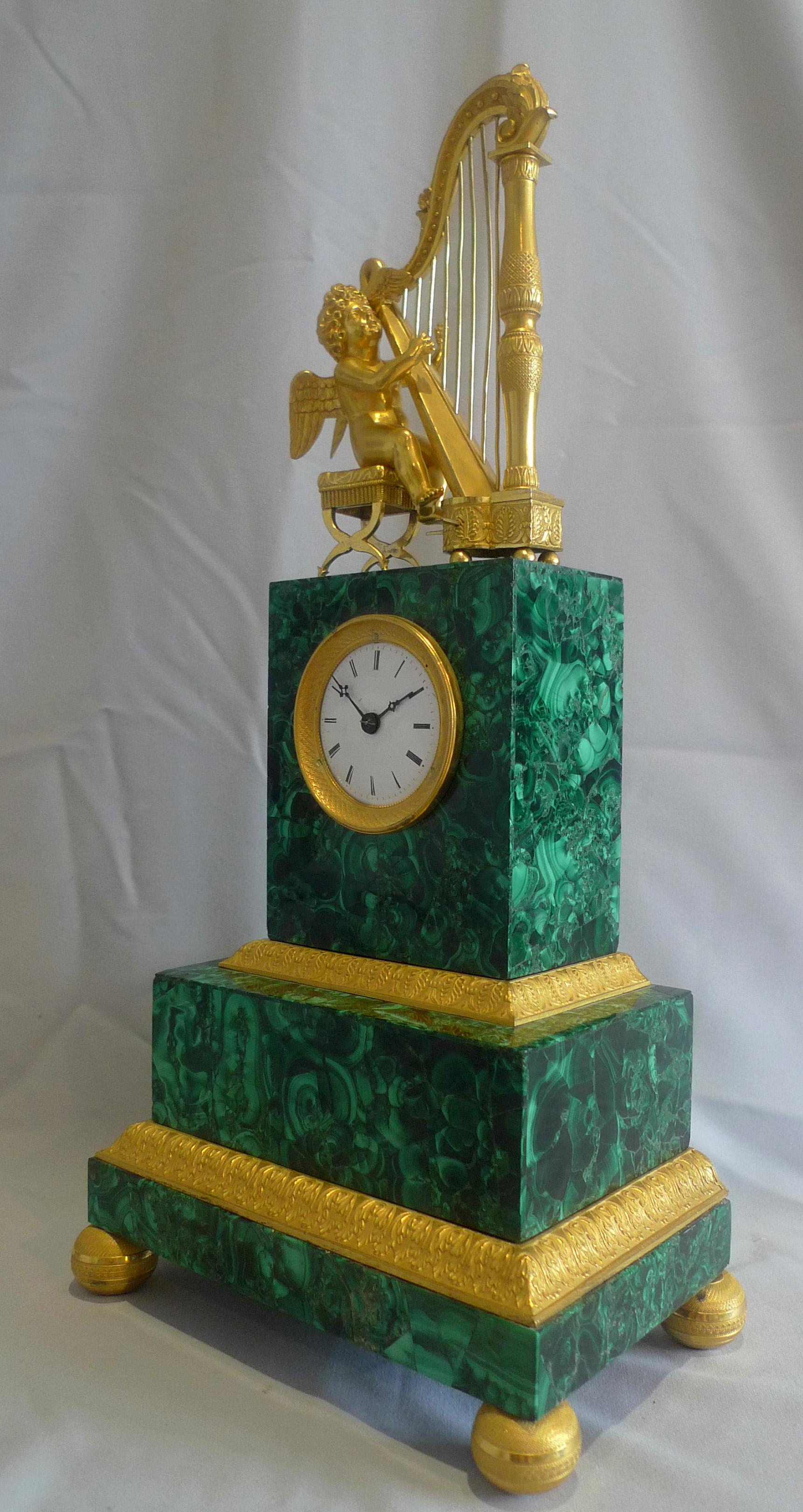 A stunning Russian malachite and ormolu mantel clock. The case possibly Russian but probably Paris, Palais Royal ( from the quality and style of the original ormolu mounts). The superb malachite veneered on to the bronze case. The malachite on all