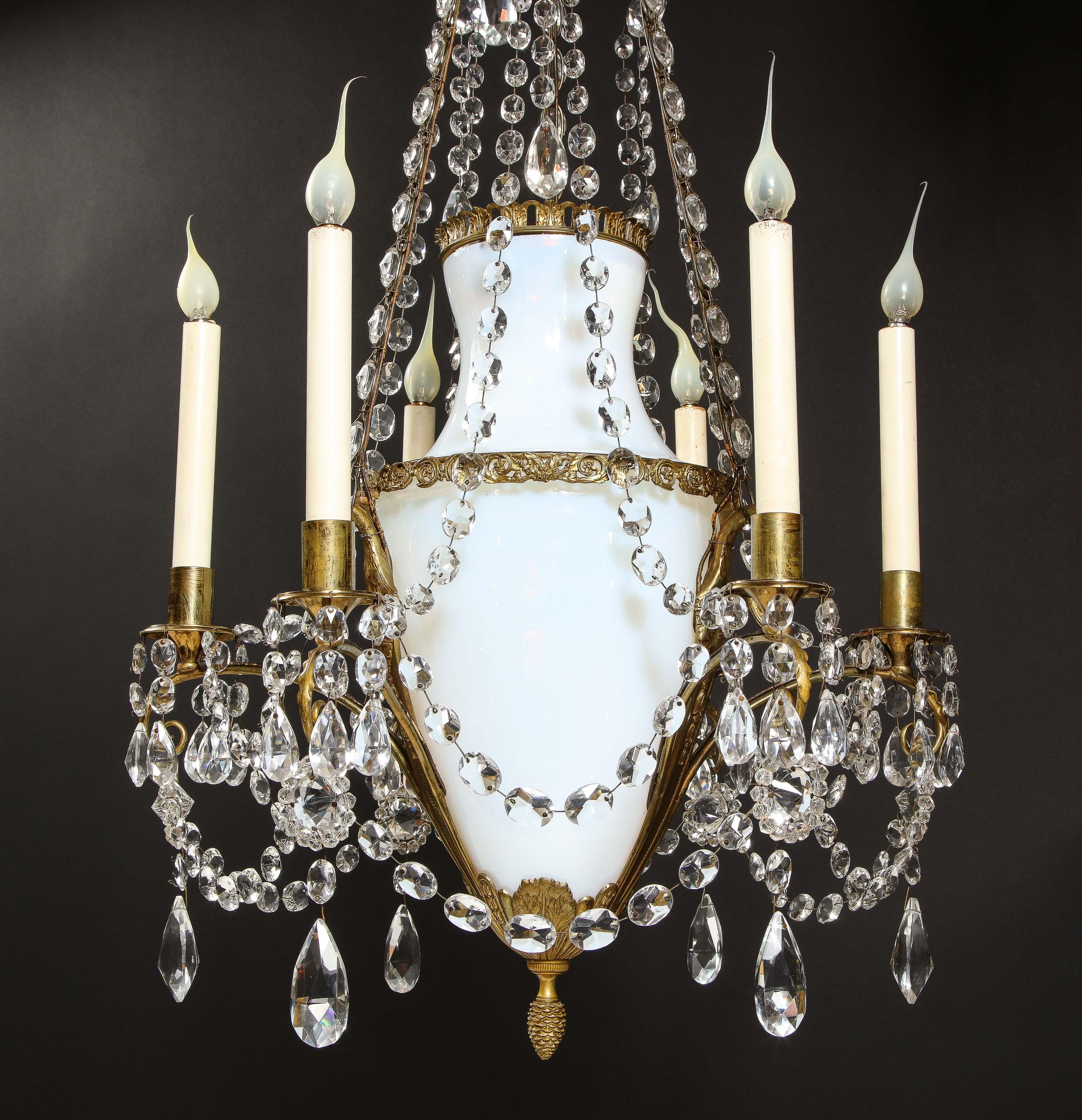 A Fine Antique Russian Neoclassical gilt bronze, white opaline glass and crystal multi light chandelier of superb quality and detail. This unique neoclassical chandelier is embellished with gilt bronze swans, further decorated with a large white