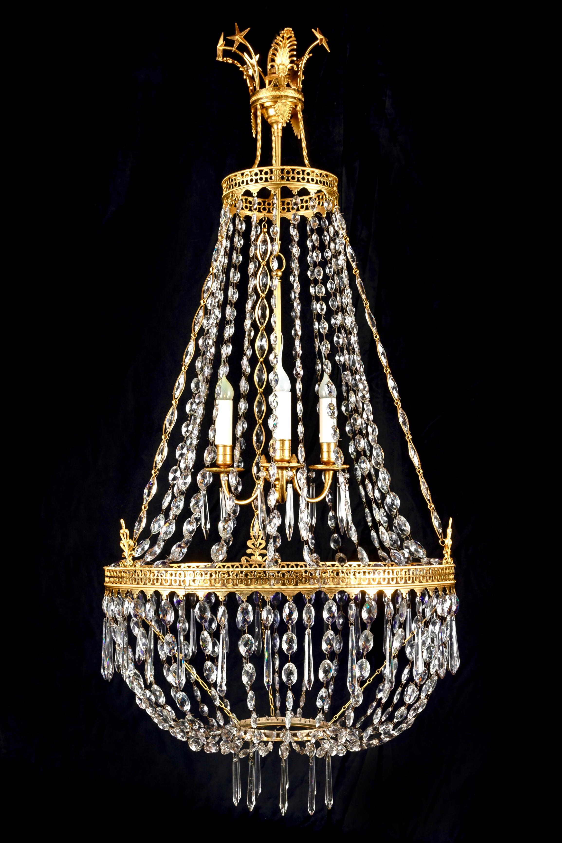 A Large Unique Antique Russian Neoclassical gilt bronze, crystal and blue glass chandelier of fine craftsmanship embellished with cut crystal prisms, crystal chains and a central blue cobalt  glass dish framed by a reticulated gilt bronze gallery.