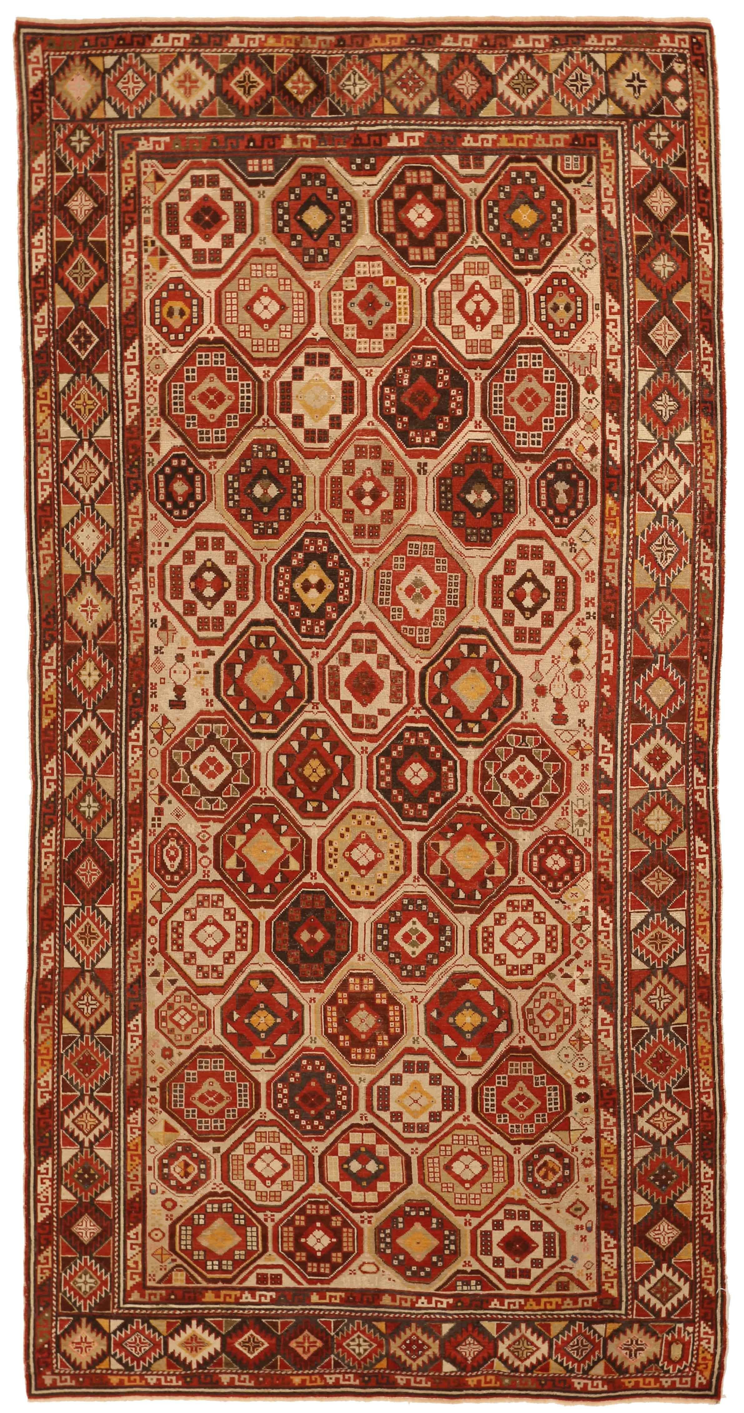 Handwoven using the highest quality wool, this Shirvan design antique Russian rug features octagons and diamond figures in various iterations. Using a bold mix of red, beige, and brown, it’s a rug created for spaces with contemporary and traditional