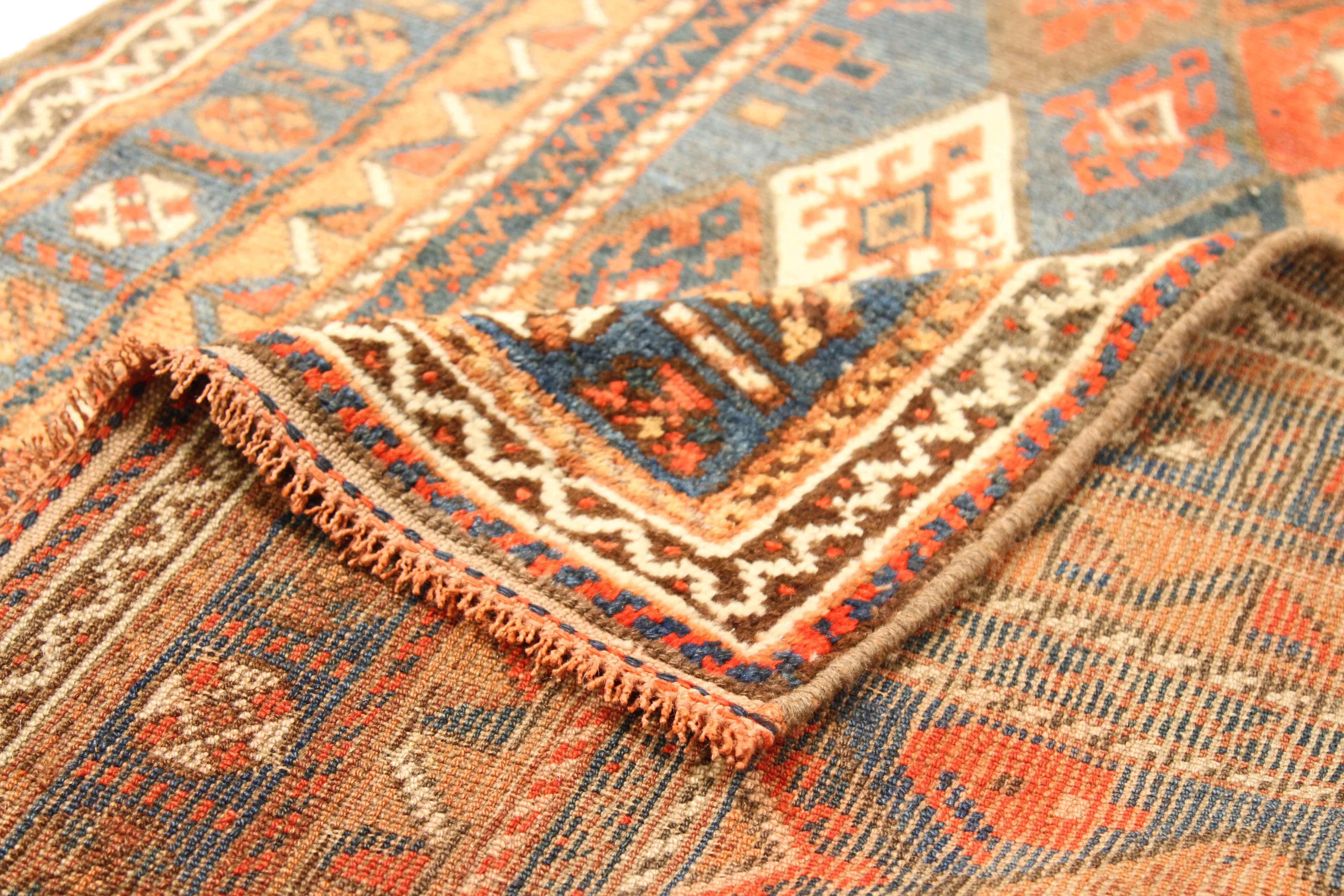 Antique Russian rug handwoven from the finest sheep’s wool and colored with all-natural vegetable dyes that are safe for humans and pets. It’s a Russian design featuring diamond and flower details using a mix of red and ivory. It has a dark green