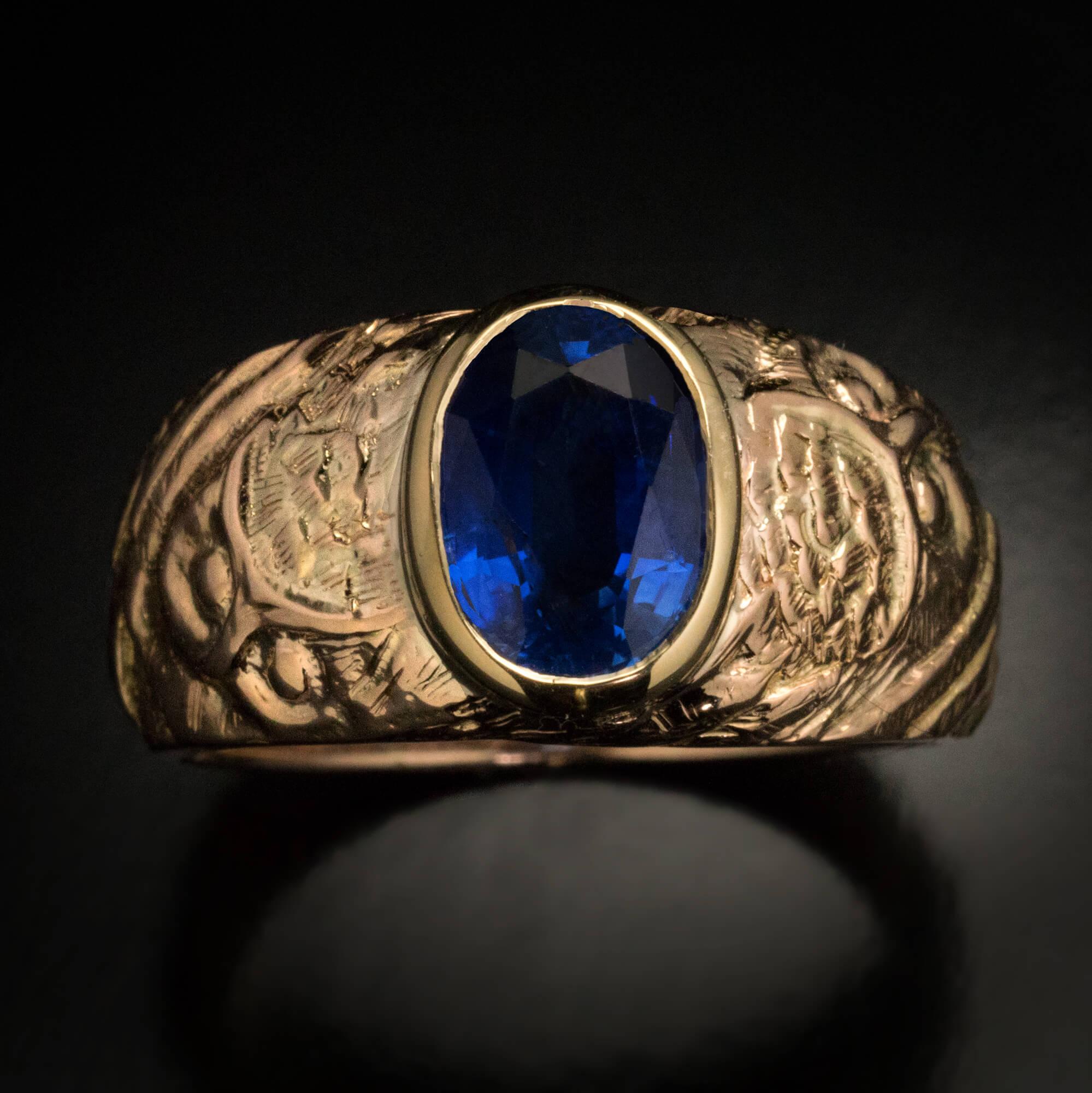 Russia, early 1900s.  This antique one-of-a-kind 14K gold ring is designed in the Russian Modern style of the early 1900s. The ring is bezel set with a fine oval sapphire of a royal blue color. The sapphire is flanked by a pair of stylized owls, a