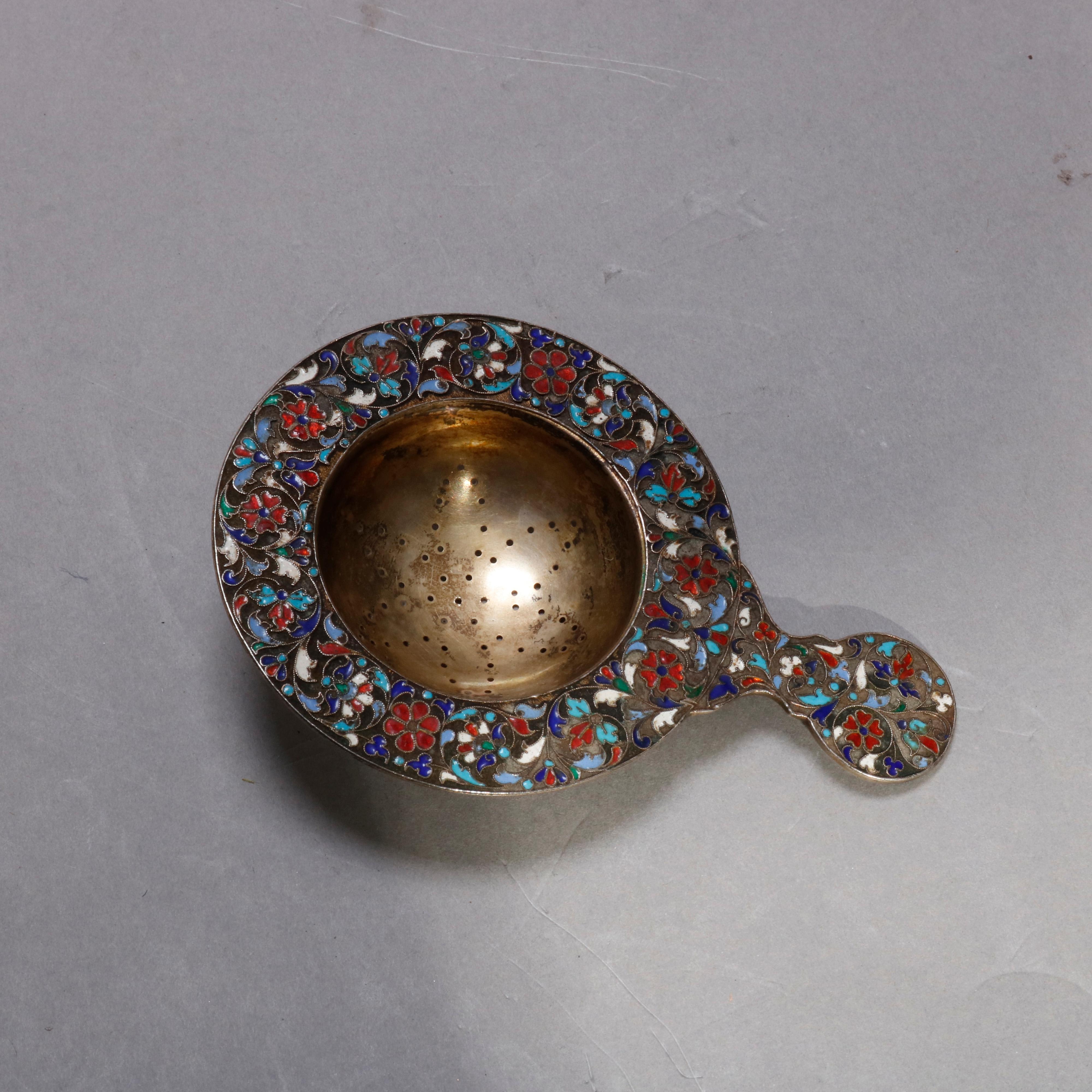 An antique Russian silver tea strainer with enameled scroll and foliate decoration throughout, unmarked, circa 1900.

Measures: 5 