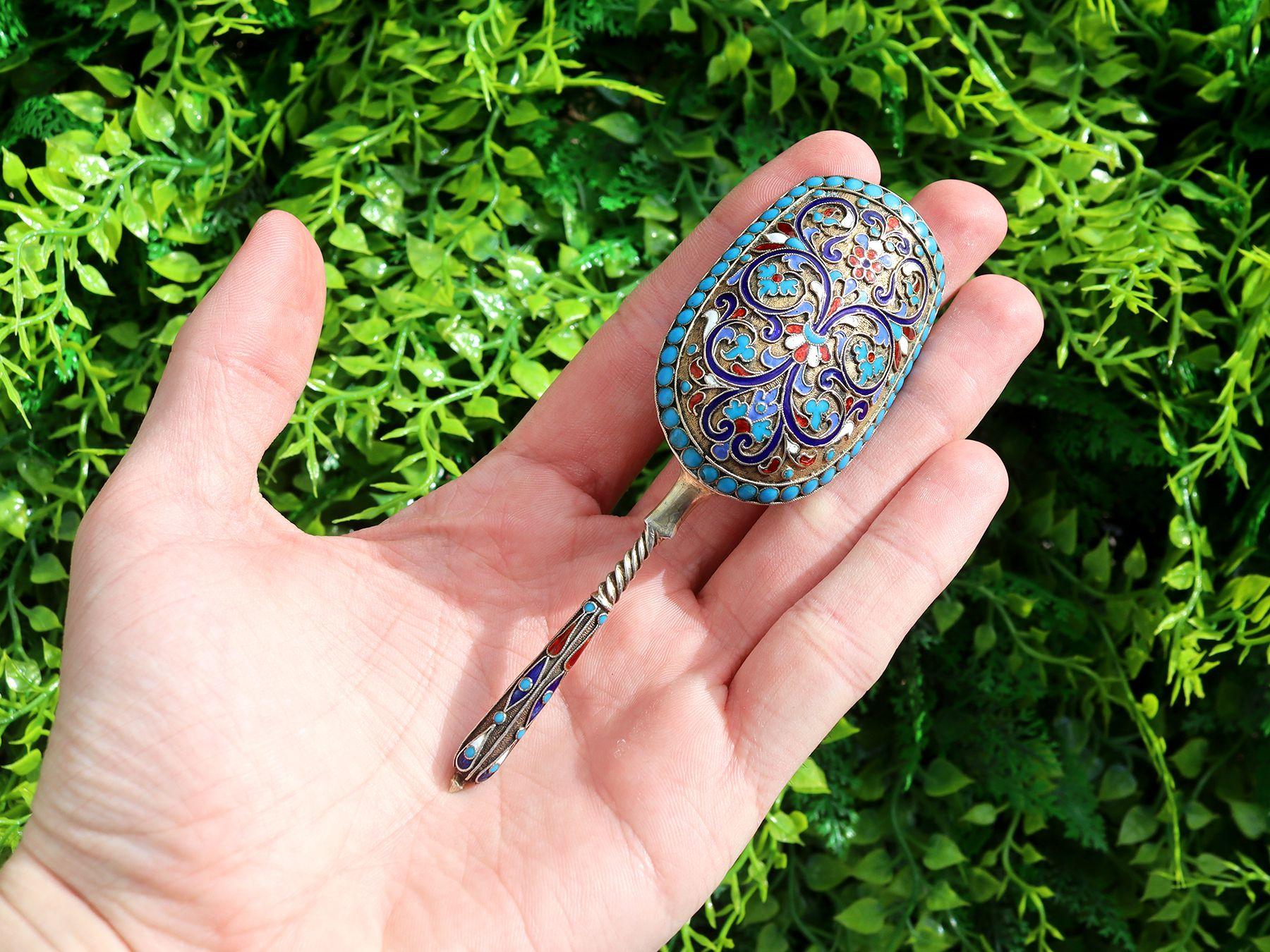 An exceptional, fine and impressive antique Russian silver gilt and polychrome cloisonné enamel caddy spoon, an addition to our Russian silverware collection.

This exceptional antique Russian silver caddy spoon has a shovel shaped bowl onto a