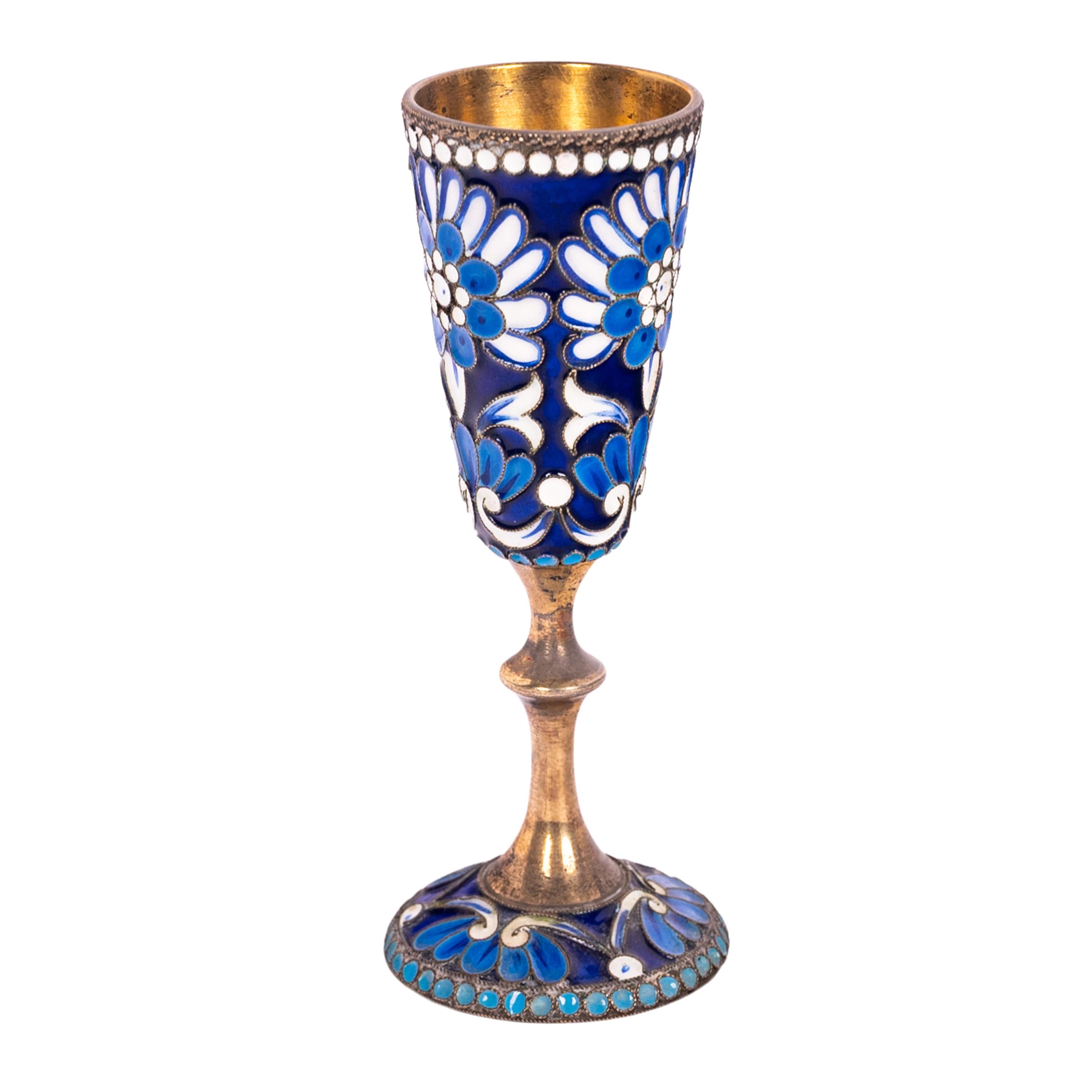 A good antique silver-gilt cloisonné Russian Imperial vodka glass/goblet, St. Petersburg, circa 1900. 
The goblet with a cobalt blue ground having a lighter blue & white floral decoration and raised on a turned silver-gilt stem with a flared foot
