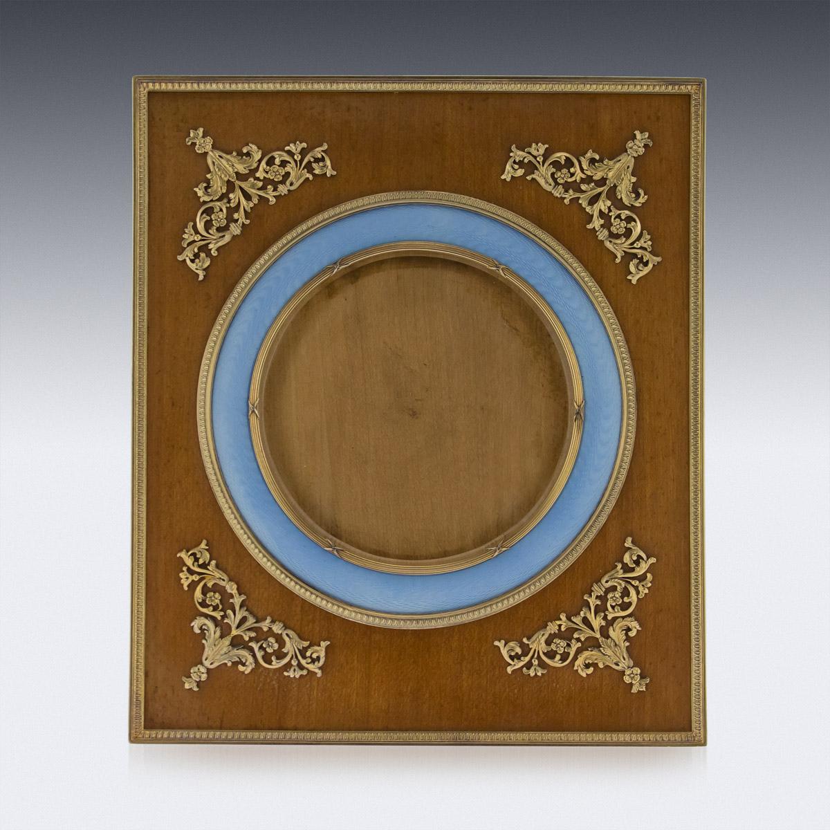 Antique early 20th century exceptional Russian silver gilt, guilloche enamel and wood photograph frame, rectangular shape, the bound reeded bezel border set within translucent light blue-colored enamel over moiré engine-turning, wood surround, back