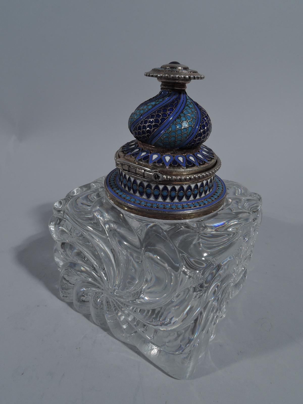 Russian silver and glass inkwell, 1888. Rectangular clear glass block with carved radiating scrolls. Silver gilt collar and hinged onion-dome cover with disc finial. Silver has enameled beading, leaf-and-dart, and fish scale in blues and white. A