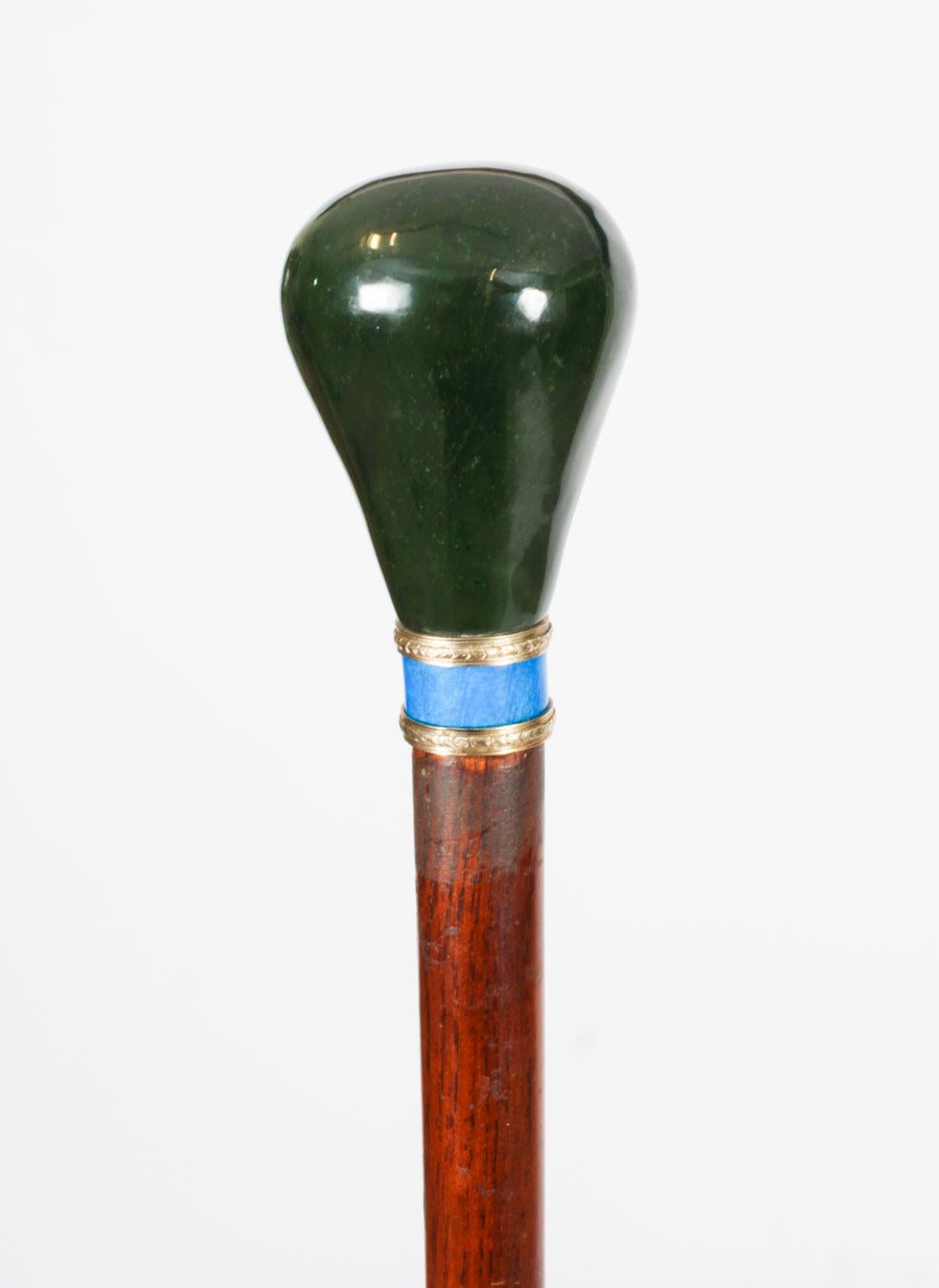 This is a beautiful antique Russian silver gilt and enamel walking stick sating from Circa 1880.

It features a decorative silver gilt, blue enamel and nephrite jade handle on a gently tapering chestnut wood shaft.

It bears the Russian silver mark