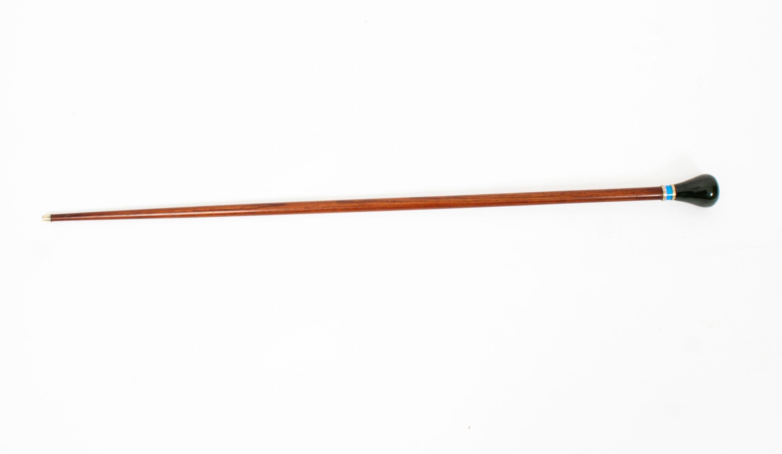 This is a beautiful antique Russian silver gilt and enamel walking stick sating from Circa 1880.

It features a decorative silver gilt, blue enamel and nephrite jade handle on a gently tapering chestnut wood shaft.

It bears the Russian silver mark