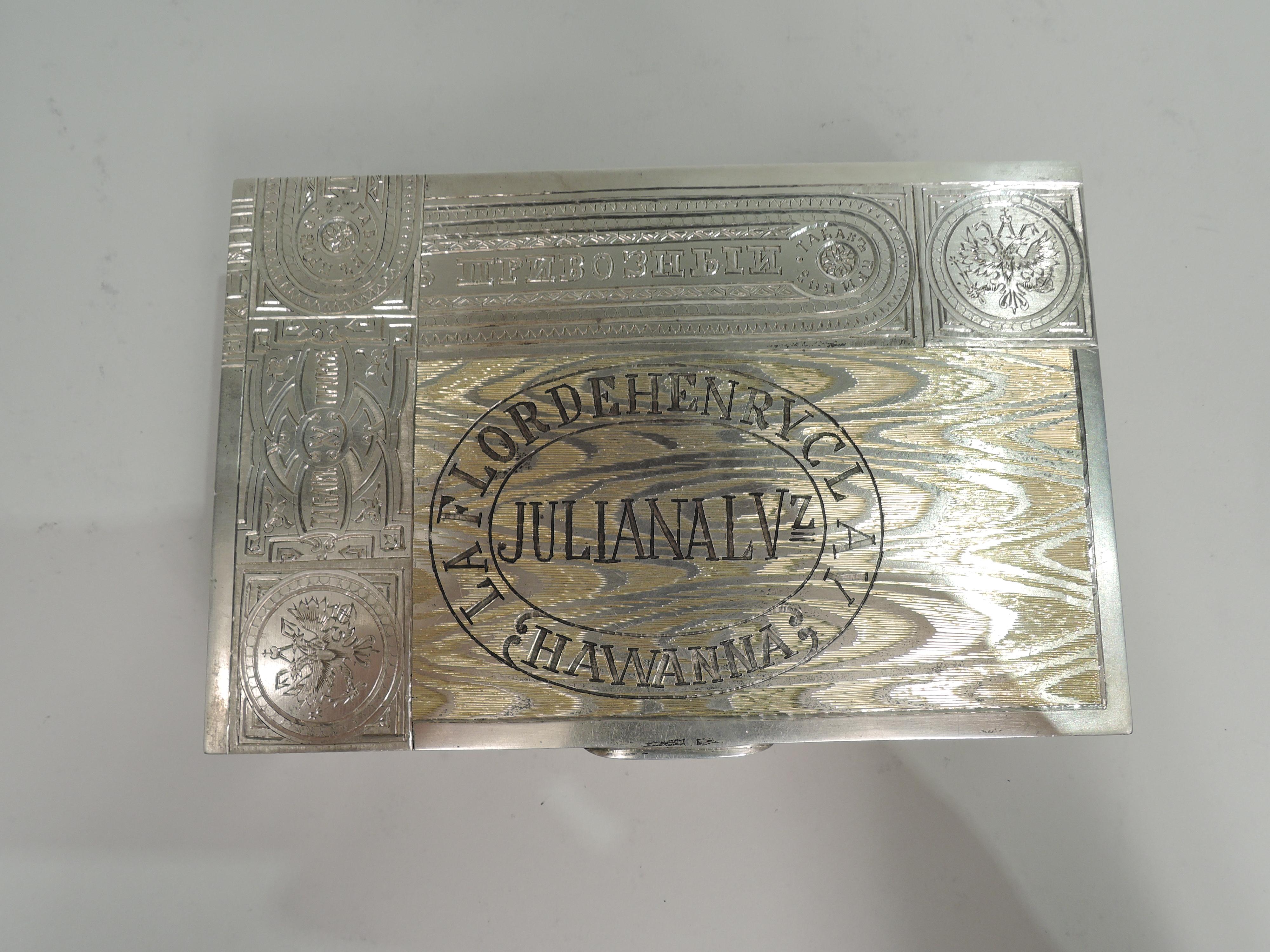 Russian 875 silver novelty cigar box, ca 1910. Rectangular with flat, hinged, and tabbed cover. Trompe l’oeil lightly gilt wood panels with realistic grain and tax stamps. Gilt interior. Based on the packaging of the very real Julian Alvarez in